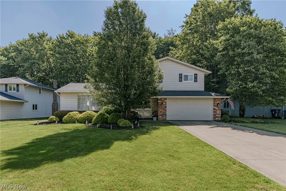 Nestled on a quiet street in Solon, 5131 Cheswick Dr offers a spacious split-level floor plan, a deep backyard, and a peaceful wooded backdrop. Well maintained throughout, this home combines comfortable living spaces with a desirable setting. Double front doors open to a welcoming foyer featuring immaculate original slate tile flooring. The spacious living room is filled with natural light from a large bow window and flows into the formal dining room. Updated LVP flooring continues from the dining room into the kitchen. The kitchen features a full complement of appliances, a tile backsplash, ample cabinet space, and a bright eat-in area. Just a few steps down, the spacious family room offers a fireplace with a brick accent wall and sliding door access to a screened-in porch overlooking the backyard. A convenient half bath completes this level. Upstairs, you'll find three bedrooms and two full bathrooms, including a primary suite with a private ensuite bath. While the lower level expands the living space with a finished recreation room featuring a generous storage closet, along with a dedicated laundry and utility room, and shower. Outside, the deep, fenced backyard provides plenty of space for recreation and entertaining, while the wooded area beyond creates a tranquil setting and added privacy.