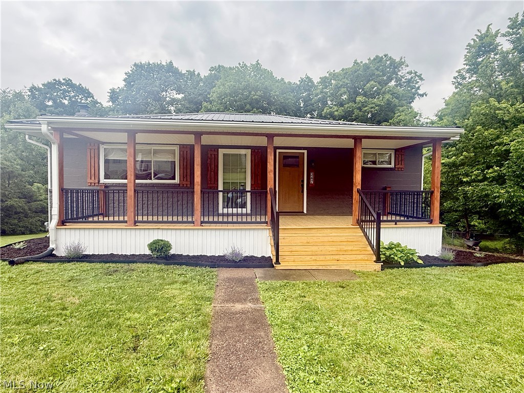 You don’t want to miss the opportunity to see this beautifully renovated 3 bedroom, 2 full bath home where every detail has been thoughtfully renovated and updated. From the moment you arrive, you'll appreciate the inviting new covered front porch with gorgeous wood accents, a brand-new front door, and outstanding curb appeal.

Inside, you will find an open and stylish interior featuring all new flooring throughout, updated plumbing and electrical, and a stunning new kitchen complete with a center island and brand new stainless steel appliances, perfect for entertaining or everyday living. The convenient main floor laundry is easily accessible from the spacious primary bedroom, which also boasts a large walk-in closet.

The finished basement provides even more living space with a cozy fireplace, wet bar, and endless possibilities for a family room, game room, or entertaining area.

Additional updates include a new metal roof, new ac unit, and a new garage door for the attached one car garage, offering peace of mind for years to come.

This move-in-ready home combines modern finishes, functional living spaces, and quality craftsmanship inside and out. Don't miss your opportunity to own this turnkey property, schedule your private showing today!