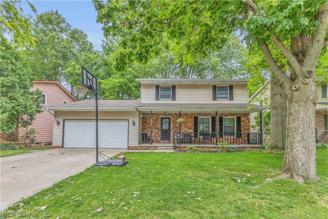 Beautifully updated 4-bedroom, 2.5-bath colonial nestled on a quiet cul-de-sac in the heart of Grafton within the highly desirable Midview School District. Charming exterior with covered front porch enhanced by striking black accents including the shutters, trim, railing, and front door, along with the convenience of an attached 2-car garage. This home has been extensively renovated. New luxury vinyl plank flooring, modern paint colors, updated light fixtures, and crisp white trim and baseboards create a fresh, cohesive feel. The spacious front living room flows seamlessly into the dining room and updated eat-in kitchen featuring two-tone cabinetry with modern hardware, refinished black countertops, stainless steel appliances, range hood, peninsula seating, double pantry closet, and a picture-perfect window overlooking the backyard. The kitchen opens to a warm and inviting family room highlighted by a stunning wood-beamed ceiling, whitewashed brick wood-burning fireplace, and built-in shelving. Just beyond, the enclosed four-season room offers a full wall of windows, two skylights, and a sliding door, filling the space with natural light and providing year-round enjoyment. Outside, the fenced backyard offers a peaceful, park-like setting with mature trees and a concrete patio—perfect for relaxing or entertaining. The main-floor half bath has been completely remodeled with wainscoting, updated flooring, vanity, toilet, mirror, faucets, and lighting. Upstairs you'll find a hallway lined with beautiful wainscoting, an updated hall bathroom, four bedrooms including the private primary suite featuring two closets and an updated ensuite bath. The partially finished basement provides additional living space with a recreation room, storage room, and laundry/mechanical area. Major mechanical updates include a brand-new furnace (September 2025), hot water tank (2023), and central air conditioning (2019). This home is move in ready. Schedule your private showing today!