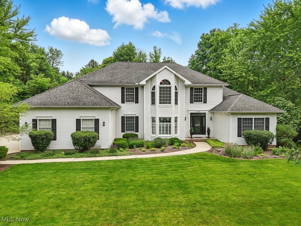 Welcome to your dream home in the sought-after Hunt Club community of Hudson! Nestled on a serene 1.85-acre lot, this stunning property offers the perfect balance of comfort, luxury, and privacy.

Step inside to discover a thoughtfully designed interior, where an open-concept layout and sun-drenched living spaces create an inviting atmosphere. The expansive kitchen is ideal for entertaining, featuring ample counter space and a seamless flow into the light-filled living area.

The luxurious first-floor master suite is a peaceful retreat, complete with a sliding door that opens to a spacious deck—perfect for enjoying your morning coffee while taking in views of the private, wooded backyard.

Upstairs, you'll find three generously sized bedrooms, each with walk-in closets, along with two full baths. A cozy additional room provides the ideal space for reading, studying, or a home office.

The full basement offers endless possibilities, whether you envision a home theater, game room, gym, or guest suite.

Don't miss your chance to own this exceptional property—schedule your private showing today and experience the perfect blend of tranquility and modern living!