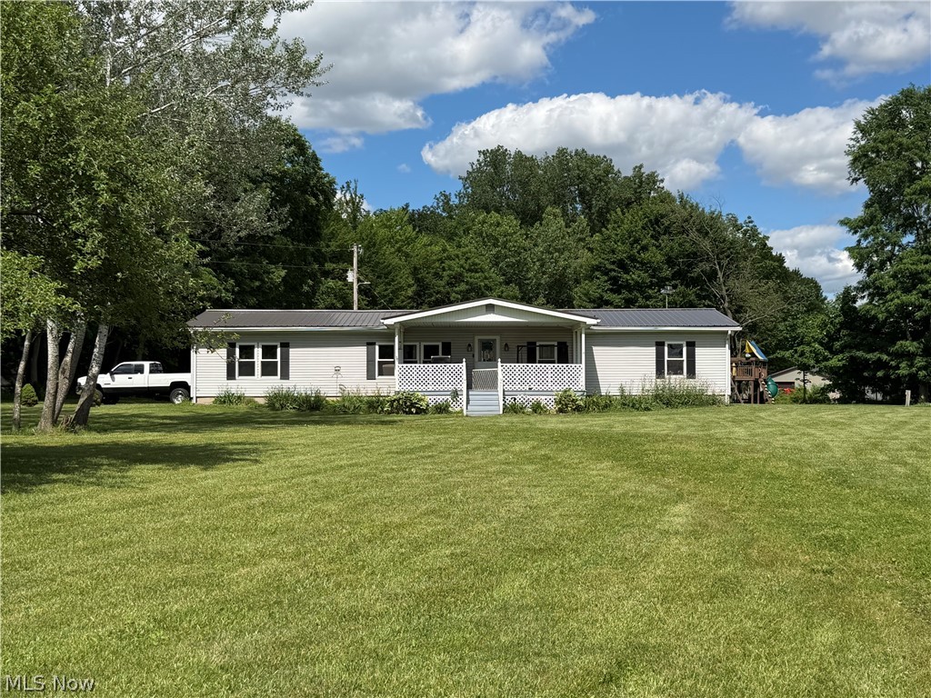 Situated on 4.99 acres, this well maintained 2100 sq ft manufactured home offers the space and versatility that many rural property buyers are looking for. The home features 3 bedrooms, including a private primary suite, a spacious living room, kitchen, dining room, bonus family room, additional full bathroom and a convenient mudroom. Outside, the property truly shines with and impressive 32x62 outbuilding providing ample space for equipment, vehicles, projects or storage - complete with a 10' overhang, perfect for enjoying summer nights and fun fishing the fully stocked pond. A smaller barn 24x32 with a pasture area adds functionality and the opportunity to raise a few animals. There is also a separate 2 car garage- 24x24 with a loft area above. The metal roof on the house, versatile outbuildings, pasture area, fully stocked pond on nearly 5 acres create a rare offering for buyers seeking country living with the space to play, work and grow! Schedule your showing today!