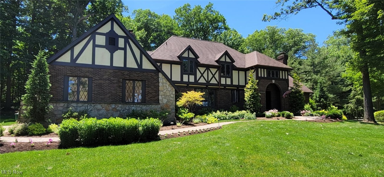 This stunning Tudor offers 4 bedrooms, 3 full baths, and 2 half baths, all set on a beautiful 2-acre lot. The spacious family room features rich hardwood floors and a striking stone fireplace, creating a warm and inviting atmosphere. The large kitchen and dinette area are designed for both everyday living and entertaining, complete with granite countertops and a center island. A formal dining room with elegant crown molding adds timeless charm.
The expansive primary suite is a true retreat, showcasing vaulted ceilings, a walk-in closet, a cozy fireplace, and a luxurious glamour bath. A four-season sunroom with a wet bar provides the perfect space to relax or entertain year-round. Additional bedrooms offer walk-in closets, while solid wood doors and trim throughout highlight the home’s quality craftsmanship.
Completing the home is a massive 30x26 recreation room with its own wet bar, ideal for gatherings, along with a rare 4-car attached garage. All of this is nestled on a picturesque 2-acre property, offering space, privacy, and elegance.