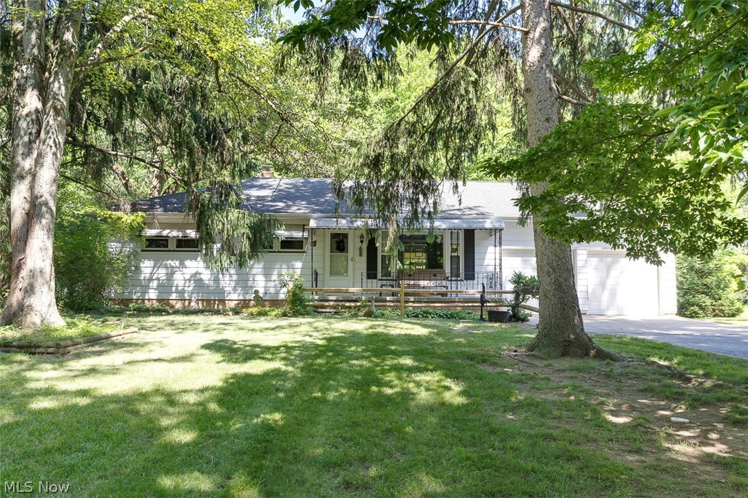 A truly rare find! This charming ranch home sits on a picturesque 1-acre lot and offers a unique opportunity for horse enthusiasts and nature lovers alike. Nestled off the parkway and within walking distance of Lake Isaac, the property features a private, wooded front setting with a covered patio, while the expansive backyard opens to additional wooded surroundings, creating a peaceful and scenic retreat. Horse owners will appreciate that the property permits one horse and includes a 23' x 17' two-stall cement block stable with a loft area. Even better, a bridle trail is conveniently located just across the parkway, providing easy access for riding. Inside, this well-maintained home showcases a remodeled kitchen with updated cabinetry and laminate countertops, a spacious dinette or dining area, and a cozy living room highlighted by beautiful hardwood floors. The generously sized bedrooms also feature gleaming hardwood flooring, adding warmth and character throughout. The basement offers excellent flexibility with multiple areas for recreation, hobbies, or workspace, including a billiard room and pub area perfect for entertaining. An attached 24' x 19' garage provides ample room for parking, storage, and projects. With just a few finishing touches, this special property offers the perfect blend of comfort, privacy, and country-style living in a highly desirable location.