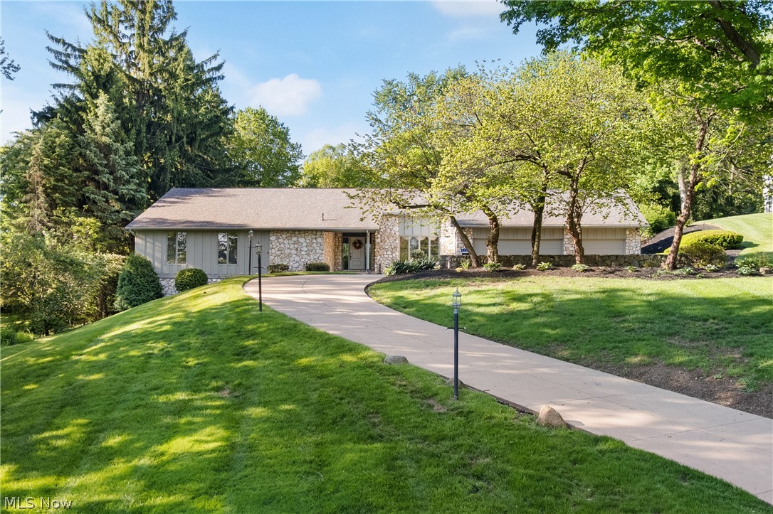 Now LOOK at This! Exceptional opportunity in the charming Avondale Neighborhood! This 4 BR, 5 bath (3 full/2 half) executive ranch home, nestled on a picturesque 1.41-acre lot, is a true gem, offering an ideal blend of comfort, space, & stunning spaces for entertaining. The large covered front reception porch invites you into the open foyer where you'll be greeted by a vast living room, highlighted by soaring cathedral ceilings and a striking stone fireplace that creates a warm & welcoming atmosphere. Natural light pours in from large windows, showcasing the breathtaking backyard views that instantly transport you to a tranquil retreat with an outdoor fireplace and spacious patio for outdoor entertaining. The eat-in kitchen with large sliding doors to the patio areas is designed for both functionality & style, featuring solid surface countertops, two dishwashers for quick and easy clean-up after parties or family gatherings. An abundance of lighting both built in and natural makes cooking a delight. The beautiful formal dining room where 12-15 could easily dine and socialize, will leave your guests with a memorable experience. 1st floor laundry with washer and dryer that stays. With four generously sized bedrooms, each equipped with walk-in closets, there's plenty of room for family or guests. The main suite is a sanctuary in itself, complete with a luxurious bathroom featuring a jetted tub for relaxation and a low-threshold shower for convenience. The finished walk-out basement is a standout feature, offering a spacious area for recreation and relaxation, complete with a full bathroom, retro wet bar, and a unique sunken seating area. With an impressive amount of storage throughout, this space provides endless possibilities for use and organization. This home’s exterior melds timeless stone and cedar finishes, enhanced further by a new roof installed in 2021. The combination of high-quality craftsmanship and thoughtful design makes this property truly​​‌​​​​‌​‌​​​‌‌​​​‌‌‌​​‌​​‌‌​​​​ one-of-a-kind.