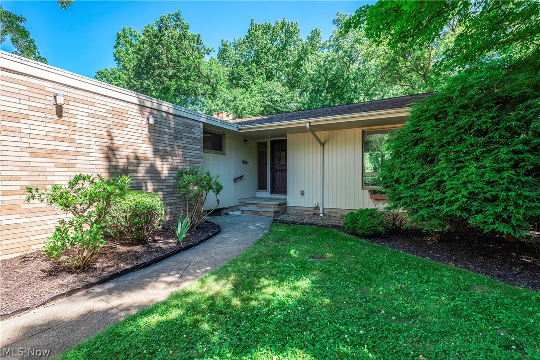 Lovely brick/cedar ranch home on sought after VALLEY lot with a mid-century vibe! Front porch and decorative glass entry door/sidelight opens into a spacious living room/dining room with light carpet/tile! Vaulted ceiling! Unique brick, 3/4 wall with wood, display shelf running the length of the top. Window wall to rear yard. OPEN kitchen with medium-stained wood cabinetry, tile flooring, light Formica countertops, built-in desk, pantry closet, skylight and cool, VINTAGE turquoise cooktop/double wall oven! Garbage disposal replaced in 2025! Open to cozy family room with hardwood flooring, brick, wood-burning fireplace with sandstone mantle and window wall to rear yard! Off the main hall is a UNIQUE split full bath with newer 4-ft. marble-look, replacement shower with new hardware and vanity/sink...other side of door is a second vanity/sink and toilet. A full bath off laundry room and a full/half bath off main hall. Hall linen closet! Two doors to rear yard off living/family rooms. Sizable wood-windows that let in tons of natural light! Mudroom/laundry room with utility sink and lots of storage cabinets off convenient, covered side porch; garage entrance, coat closet, closet stair-storage leading up to storage under the eaves. Two secondary bedrooms with wood-look, vinyl flooring/double closets! Master suite with THREE walk-up closets, 1/2 wall brick, decorative wall with display ledge, windows to rear...attached master bath with stall shower, double vanity (sink area and make-up area)! All appliances remain including a newer washer/dryer and newer full refrigerator in basement. LOWER LEVEL is very large...the whole footprint of the home! Finished area with carpet, woodwork, walk-in closet and full bath. The remainder is unfinished and divided into two areas. Oversized, attached, two-car garage with door opener and skylights for extra light! Full HVAC replacement in 2025! Paver patio to enjoy your semi-private rear yard. Good condition with lots of potential...