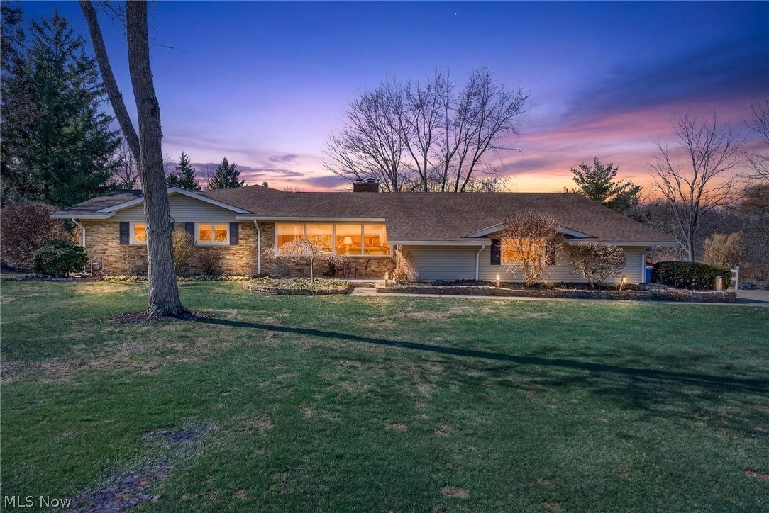Welcome to this beautifully renovated 4-bedroom, 4-bath ranch set on a private 1.5-acre lot in Novelty. This spacious home features vaulted ceilings with exposed wood beams, two fireplaces, and an open layout with new flooring that creates a warm and inviting atmosphere. Enjoy your morning coffee in the stunning vaulted sunroom addition with picturesque views and direct access to the expanded deck, bridge walkway, and pavilion. Perfect for relaxing or entertaining. The updated kitchen offers granite countertops, a large island, and newer stainless steel appliances.

The primary suite features a spa-inspired bath with a large tiled walk-in shower, frameless glass door, soaking tub, and an expanded walk-in closet with private deck access. The finished walkout basement provides additional living space with a second kitchen, tiki wet bar, workshop, and ample storage, ideal for entertaining, hobbies, or extended living. Outdoor living shines with a renovated deck, pavilion, outdoor fire pit, and lower-level concrete patio, all overlooking the peaceful 1.5-acre setting. Additional updates include a new furnace (2025), upgraded electrical, newer siding, gutters, garage door, windows, invisible fence, and a large garage/shed for extra storage.

Located on a quiet street just minutes from schools, shopping, and dining, and part of the highly desirable West Geauga School District.