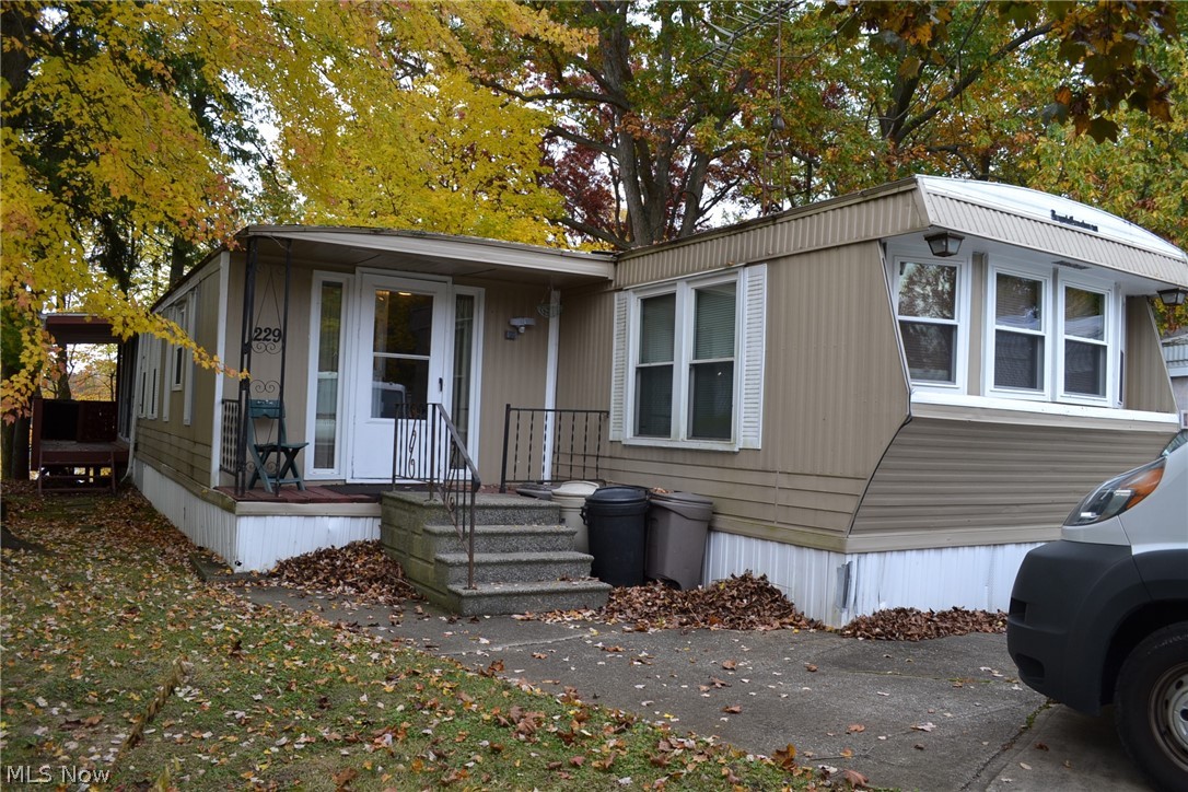 This charming double wide lakefront manufactured home boasts a picturesque setting with stunning views of Paramount Lake. The highlight features include a delightful 4 seasons sunroom and a deck complete with a gazebo, providing the perfect spots to soak in the breathtaking scenery. Imagine waking up to the ever-changing beauty of nature right from your own sunroom or enjoying leisurely afternoons on the deck overlooking the serene lake. Whether it's fishing, swimming, or kayaking, you'll have easy access to recreational activities just steps away from your back door. Nestled within the Westwood Lake community, residents have access to a private beach, park, pavilion, and playground, enhancing the overall lifestyle experience. Despite the tranquility of the surroundings, convenience is not compromised, with the property being just a short drive away from various shopping and dining options. Experience the perfect blend of outdoor living, convenience, and affordability in this lovely home, where every day feels like a retreat amidst the beauty of nature.