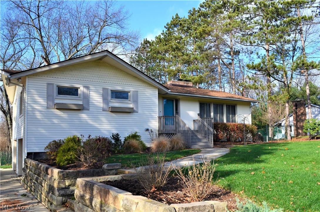 Amazing updated raised ranch presents park-like, peaceful setting with fenced yard and mature wooded backdrop.  Living room features brick fireplace and wall of floor to ceiling windows.  Newer kitchen offers maple cabinetry, all appliances including new gas stove, fireplace (see-thru to liv rm), and dining area with French doors to multi-level deck.  Master bedroom with updated private bath (walk-in tiled shower and vanity) and closet organizers, two additional bedrooms, and main bath complete the first floor.   Fabulous walk-out lower level boasts family room with fireplace, office/4th bedroom, full bath, and laundry room.  Additional highlights include oversized concrete drive, newer 
uni-lock brick retaining walls and walkway, and spacious stamped concrete patio.  Noteworthy updates are roof and siding, kitchen, windows, HVAC, and much more.  Close proximity to metro parks. Don't miss this incredible charming home and property! .