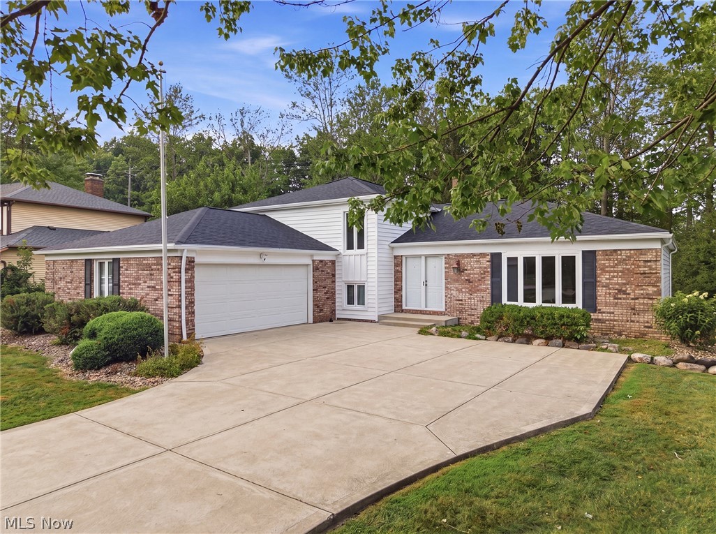 Offered for the first time by its original owner, this well-maintained split-level home combines generous living space, thoughtful updates, and a beautiful, wooded setting in one of Solon's most convenient central locations. Designed for entertaining and comfortable everyday living, this welcoming floor plan has spacious rooms and exceptional storage throughout. The vaulted living room is filled with natural light from a large bay window, creating an open and inviting first impression. The adjoining eat-in kitchen is both functional and attractive, featuring granite countertops, quality cabinetry with pull-out shelving, two pantry closets, and plenty of workspace for meal preparation. Just steps away, the expansive family room offers the perfect gathering space with a cozy gas fireplace, wet bar, and plenty of room for relaxing or hosting family and friends. The main level also includes a convenient laundry room, a half bath, and a versatile fourth bedroom or private home office. Upstairs, the spacious primary suite offers a walk-in closet and a private full bath with granite countertops. Two additional bedrooms share a well-appointed hall bath, providing comfortable accommodations for family or guests. Abundant closets and a partially waterproofed basement provide outstanding space for organization, hobbies, and seasonal storage. Major updates provide peace of mind for years to come, including a new furnace (2024), central air conditioning (2025), roof, gutters, and siding (2026), driveway (2015), newer windows and exterior doors throughout, plus the added security and convenience of a generator. Surrounded by mature trees on a private wooded lot, this home offers a peaceful backyard retreat while remaining just minutes from everything Solon has to offer. With its quality construction, meticulous care by its original owner, and highly desirable location, this is a rare opportunity to own a home that has been lovingly maintained and is ready for its next chapter.