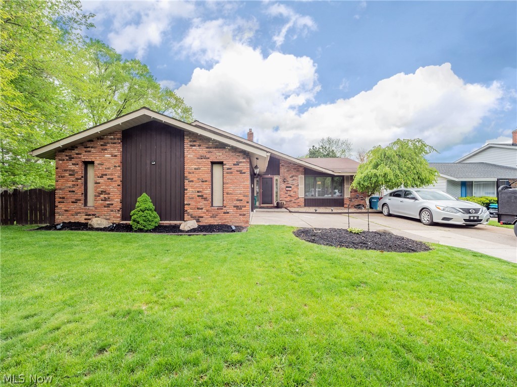 You're going to love coming home to this gorgeous split level in North Olmsted. Step onto the Luxury Vinyl Tile (LVT) flooring in the Living Room as you walk through the front door, and you'll know just how comfortable life can be. This spacious, light-filled room with slightly vaulted ceilings retains plenty of warmth and charm, no matter how you arrange it. Gorgeous LVT flows into the Dining Room, for easy cleaning - whether it's for meals, or a more formal affair. The kitchen offers excellent storage and plenty of space to move around, not to mention an informal dining nook. Or, head out to the heated sunroom for almost-al fresco dining in style. However you choose to relax, it's easy to move between indoors and out, with this space as a happy medium. There's plenty more space to enjoy in the carpeted family room on the lower level. With its fireplace and adjacent half bath, you may find yourself spending your free time right here. All of this and 3 carpeted bedrooms, including a ge