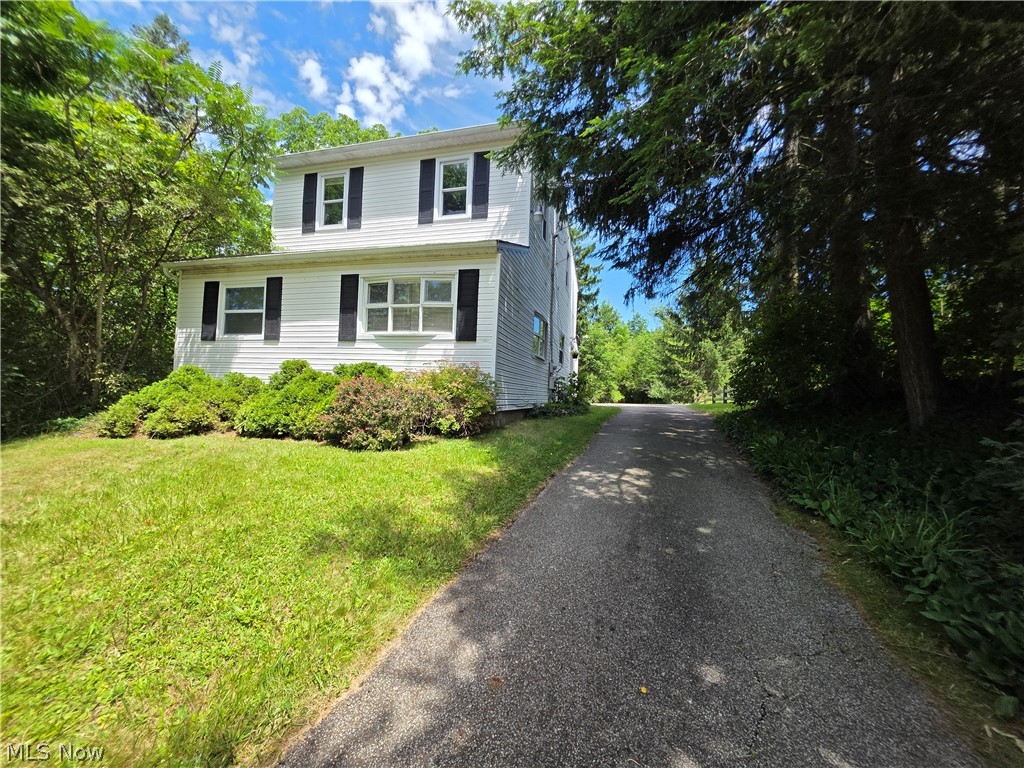 Tucked away in secluded Aurora, this charming hillside home offers privacy, peaceful views, and a sweet creek winding through the property. Bright and cheerful throughout, the home features newer carpet, updated kitchen cabinets and counters, plus flexible living spaces including a playroom or study with a large picture window and a potential home office. Outside, enjoy a huge deck, one-car garage, workshop, and a unique setting ready for your creative vision.