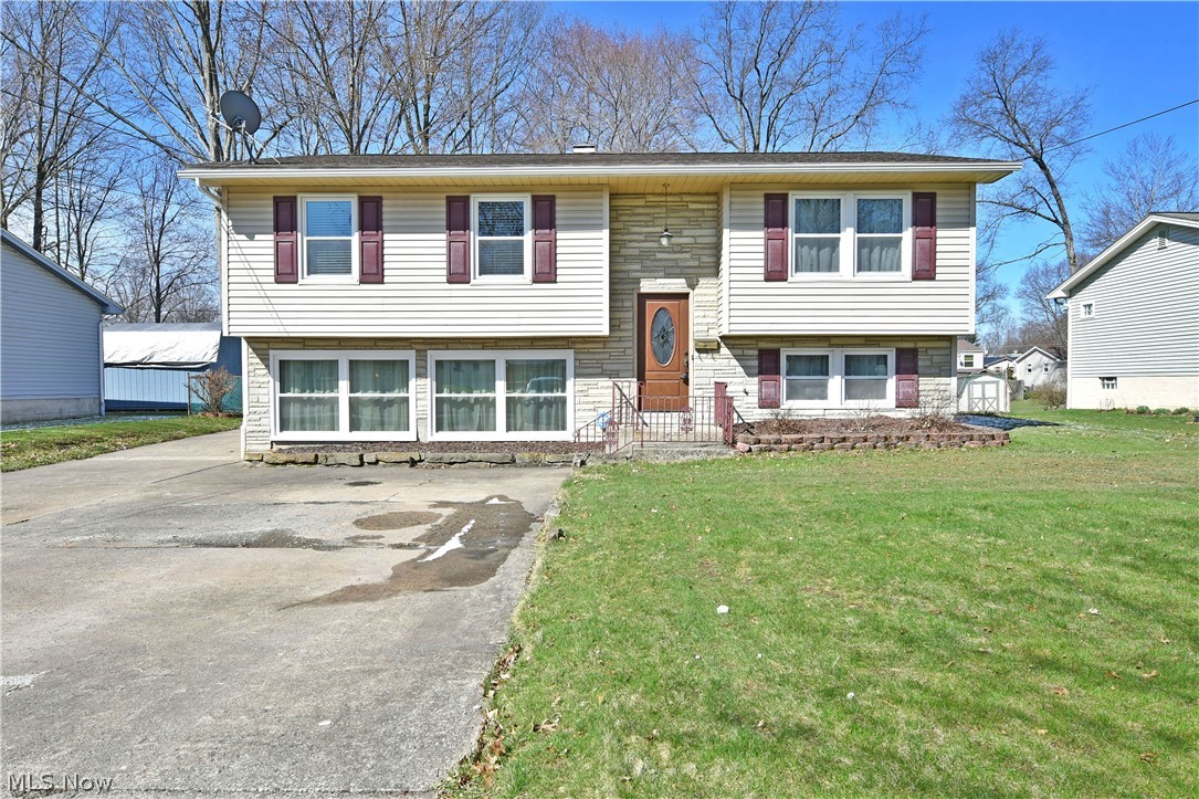 A split level to be seen, this beautiful Austintown home is quick to take your breath away! A handsome 
exterior gives way to two floors of perfectly styled living space that's sure to surprise you. Sat on a 
sizeable lot, a concrete drive sweeps past the home to find a detached two plus car garage and a 
substantial, elevated rear patio. A discerning eye will notice the row of windows where an attached 
garage is usually found; these provide an absolutely delightful lower living space that you’ll quickly fall in 
love with. An ornate entry door leads up the casual main floor where a welcoming living room bathes in 
the natural light from the large picture window. Lush carpets flow down the main hall and into the three 
bedrooms. The combined rearward kitchen and dining areas are awash in a deep blue color that 
contrasts the bright white cabinets, glass tile backsplash and hardwood styled flooring. Dining enjoys 
scenic views and plenty of sunlight from the sliding glass door
