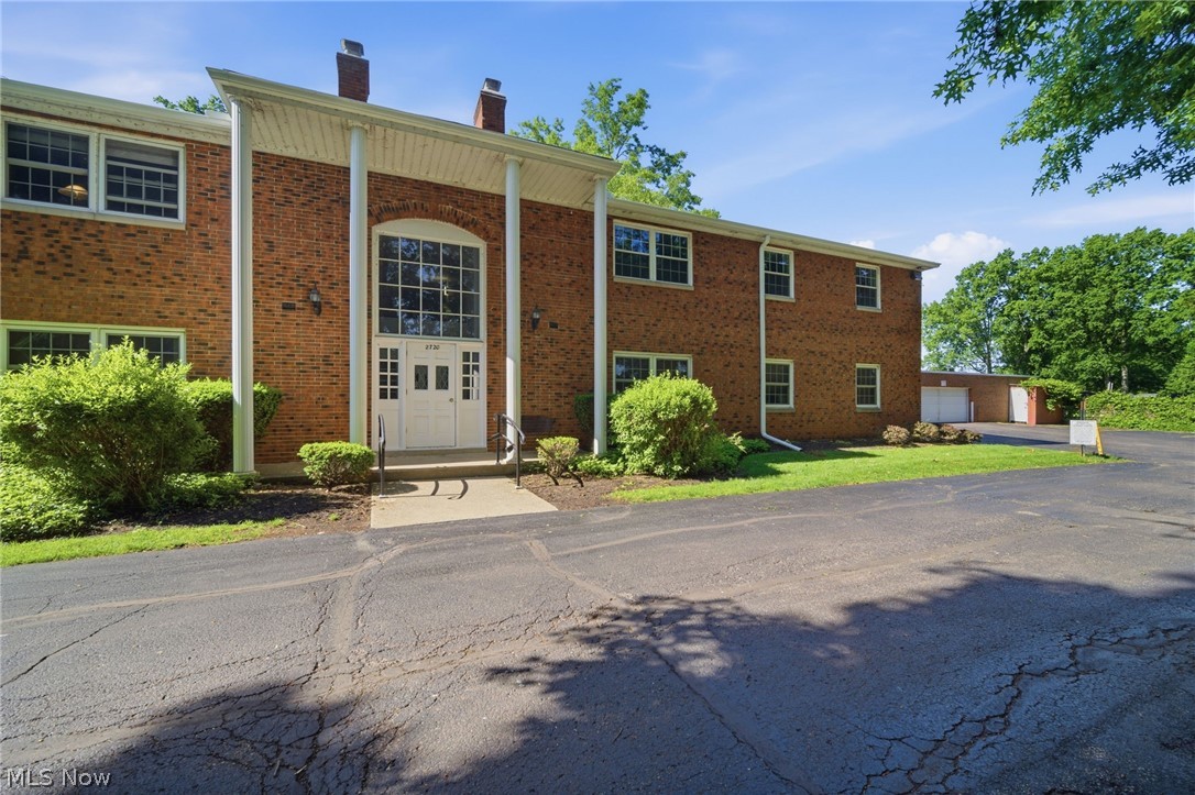 Welcome home to Heritage Circle! Tucked away on a quiet cul-de-sac in the heart of Rocky River, this exceptionally spacious second-floor, one-bedroom condo offers the perfect blend of comfort, convenience, and low-maintenance living. Step through the entry foyer with newer LVP flooring into a seamless, open-concept layout. The expansive living and dining areas flow effortlessly, anchored by a stately, floor-to-ceiling brick gas fireplace—perfect for cozy evenings. The vintage mid-century kitchen features excellent counter space and all appliances, including a dishwasher. Retreat to the massive primary bedroom, large enough to accommodate any size bedroom set, featuring a deep, oversized walk-in closet with incredible storage potential. A large full bath, two generous hallway closets, and private second-floor storage locker ensure you have room for everything. Located in a quiet, secure building with only eight units, you will enjoy effortless living at its finest. Includes an assigned garage space just steps from the entrance, plus ample guest parking. Take advantage of the beautifully landscaped grounds, a picnic area with grills, and a fantastic updated in-ground pool and party room for seamless year-round entertaining. Clean, shared laundry is conveniently located on the first floor. Enjoy ultimate peace of mind with low HOA dues that cover all utilities (except electric). This tranquil setting boasts immediate access to the best of Rocky River—just moments from premier shopping, dining, the scenic Rocky River Reservation, and top-rated schools. Don’t miss this exceptional opportunity to embrace a vibrant, turn-key lifestyle. Contact your favorite Fedora-wearing REALTOR® today to schedule your private tour!