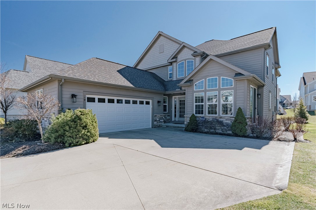 Tucked within the sought-after Sterling Lakes community, this striking contemporary home at 3900 Matisse Circle offers a sophisticated blend of modern design, open space, and effortless everyday living in the heart of Pepper Pike. Built in 2019, the residence welcomes you with a dramatic first impression—an elegant foyer anchored by a floating staircase and rich wood flooring that flows seamlessly through the main living areas. The spacious kitchen is beautifully appointed with granite countertops, stainless steel appliances, a tile backsplash, and an oversized center island perfect for gathering. A large sun-filled eating area with walls of windows and sliding door access to a side patio brings in abundant natural light and creates an effortless indoor-outdoor connection. The kitchen flows seamlessly into an impressive two-story living and dining space, where expansive windows and a dramatic stone fireplace create a warm yet elegant setting for everyday living and entertaining. Double doors off the living room lead to a private study lined with a full wall of windows—an ideal home office or quiet retreat. The first-floor primary suite offers comfort and privacy, featuring two generous walk-in closets and a spa-like ensuite bath with stone countertops, a soaking tub, and a step-in shower. The primary sitting room offers the potential of a fourth bedroom. Upstairs, a spacious loft overlooks the living and dining areas below. Two additional bedrooms share a full bath with a double-sink granite vanity, with one bedroom enjoying direct access to the bathroom. The full basement remains unfinished but offers excellent potential for future living space. Two smaller patio areas—one off the backyard and one off the kitchen—provide inviting outdoor spaces with minimal upkeep. With its contemporary layout, abundant natural light, and convenient location near shopping and highway access, this exceptional Pepper Pike home offers a refined and effortless modern lifestyle.