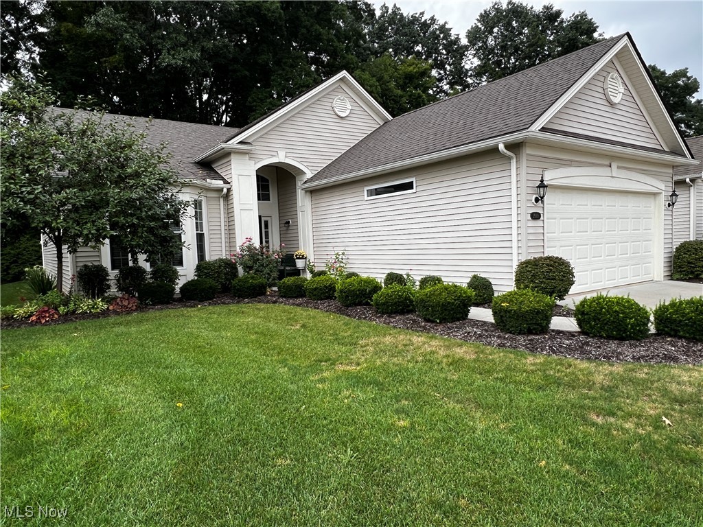 Welcome to 2069 Stonebridge Crossing in Stow.  This Villa Style, free standing, ranch home offers 3 bedrooms (one used as a den), 2 full baths is an Open Concept Layout. This home offers a beautiful and comfortable living space.  The large eat-in kitchen offers lots of cabinets, large granite counertop with breakfast bar, tile backsplash, pantry, transom window and under the cabinet lighting which gives a modern feel to this functional kitchen.  Hardwood flooring throught the foyer, eat-in kitchen and additional sitting room/sunroom which is adjacent to the kitchen eatingarea.  The sitting room/sunroom offers large windows at the back of the room and a slider which leads to the pressed concrete patio that has recently been sealed. 
The Great Room offers a gas fireplace with blower and recessed lighting.  The floor plan offers an owners suite with an attached ensuite with beautiful pillars, large windows with wood blinds and is perfect for watching televsion or reading.  The owner's bathroom containing double sinks, recycled marble countertops, large tile shower and walk-in closet. The second bedroom has an adjacent bath  and has a large closet, bay window with wood blinds and beautiful window seat for extra storage. The additional bedroom/den is perfect for overnight guests.   You will love the private backyard with addtiional trees and extensive landscaping and a pressed concrete patio, which has recently been sealed, and offers a nice seculed space to eat outside or just relax.  This home is 5 years new and been maticulously mantained. The oversized garage has a water spigot, drain and staircase which lead to a large storage aea above the garage.  No need for pull down stairs.  This home is in impeccable condition.  If you're looking to downsize a bit but still want to garden, planting flowers but not mow, you'll love living in The Villas of Stonebridge Crossing.