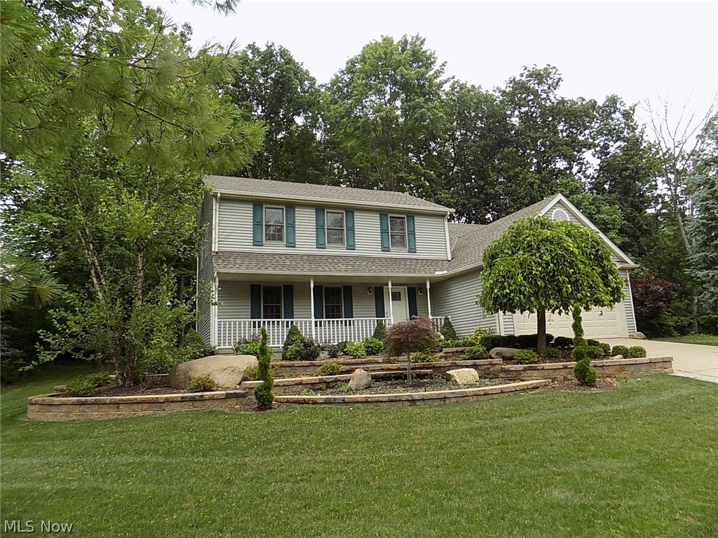 Move-in ready colonial, with full front porch, is located in popular Greenwood Village, a planned community with indoor & outdoor pools, tennis and more!  This home is nestled in the woods on a cu-de-sac*Bike trail right in your back yard*Formal living & dining rooms off foyer*Updated kitchen with pantry & sliding door to multilevel deck*Step down family room w/ brick fireplace & two-story vaulted ceiling*Kitchen & family room overlook the private yard*Spacious laundry/mud room & half bath complete the first floor*The two-car garage with newer concrete floor*Upstairs there are 4 bedrooms, including a Master suite w/walk-in closet  & newly updated with full bath, oversized tile/shower tub & skylight*Loft was converted to 4th bedroom* Twelve course lower level has been waterproofed (with a transferable warranty) and roughed-in for a bath*Updates include roof 2014, garage floor 2014, hot water tank 2012*Seller has redone first floor*Newer light fixtures throughout, door handles, painting,