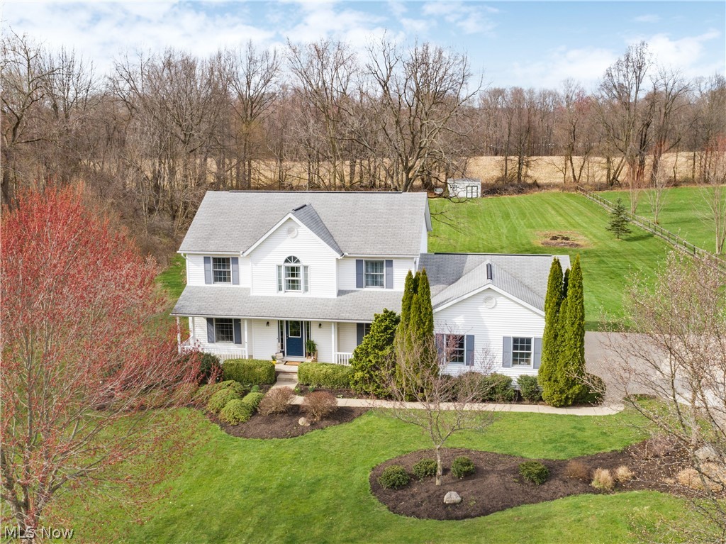 Stunning 4 bedroom, 3 bathroom, colonial sitting on over two acres in Canal Fulton! This beautiful home has been cared for by one owner. Welcome to a completely remodeled main floor with the open concept that is perfect for entertaining! New wood plank flooring and modern fixtures throughout. The eat-in kitchen boasts white, custom Kraftmaid cabinets, including a large pantry, undermount sink overlooking the large backyard, leathered granite countertops with tile backsplash, plus new stainless steel appliances including a built-in 25 bottle wine fridge! A separate living area which open through french doors, a formal dining room, first floor laundry and half bath completes the main floor. 4 generously sized bedrooms upstairs, plus a main bath with double vanities. The master suite has vaulted ceilings, a walk-in closet, and double doors taking you into the bathroom that features a soaker tub and vanity with granite countertops. Sliding glass doors from the kitchen takes you back onto t