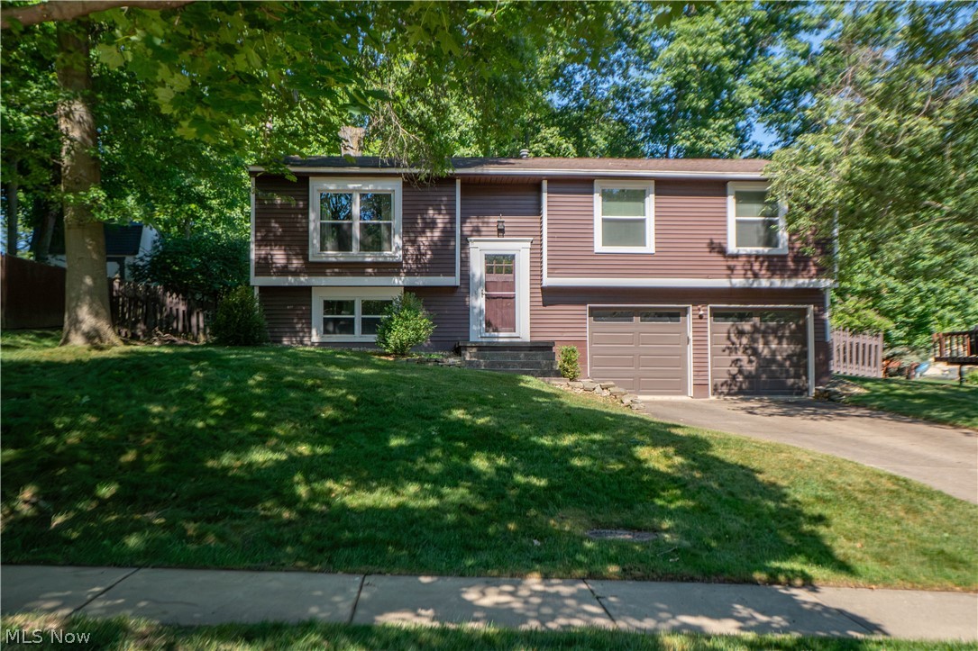 This Medina bi-level offers a spacious and unique layout with thoughtful additions, comfortable living areas, and a wonderful backyard setting. Step inside to a welcoming foyer where the split staircase leads you to the main living level featuring oak hardwood floors throughout the main level. The living room offers an inviting place to gather and flows seamlessly into the dining area, creating an easy layout for everyday living or entertaining. Just beyond, the generous family room addition provides even more space to relax, complete with a wood-burning fireplace and plenty of natural light.

The eat-in kitchen features an abundance of custom cabinetry, a wall oven, cooktop, microwave, refrigerator, dishwasher, and convenient storage details, including pull-out spice racks. Down the hall, a custom pantry closet adds even more functionality. Three bedrooms are located on the main level, including a primary bedroom with its own private full bathroom. A second full bath serves the additional bedrooms.

The lower level expands the living space with a large finished recreation room, perfect for a media area, playroom, home gym, or additional entertaining space. You will also find a half bathroom, laundry area with washer and dryer, plus a spacious unfinished storage room with floor-to-ceiling shelving and an additional utility/storage area.

Outside, enjoy a deck overlooking the tree-filled backyard, offering room to relax, garden, play, or entertain. The fenced backyard also includes a storage shed for lawn equipment and outdoor essentials. A 2-car attached garage adds everyday convenience. Located in the Lauren Glens subdivision near Roscoe Ewing Park, Heritage Elementary, and a nearby disc golf course, this home offers space, functionality, and a desirable Medina location.