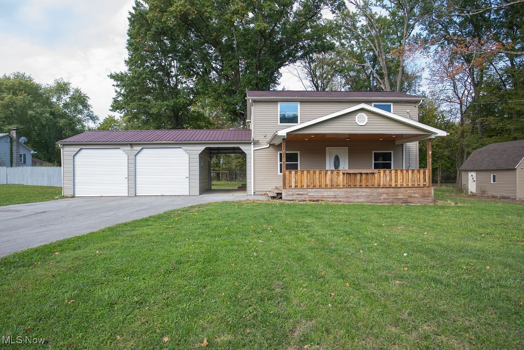 ROOM TO ROAM! MODERN 4 bedroom VINYL SIDED 2 story colonial situated on 1.64 acres of land in Poland Twp., Ohio, Lowellville local school district. Large attached modern 25 x 24 garage along with a 24 x 10 Breezeway plus there is an additional detached garage. Enjoy the summer months on the oversized covered front porch and rear patio. Home features: Dining room, spacious living room, first floor bedroom or can be used as office, 3 bedrooms upstairs with the master bedroom that has alcove design for a vanity or sitting area and large walk in closet. Full basement with access leading to rear yard. If you've waited for exceptional value-- this is it!