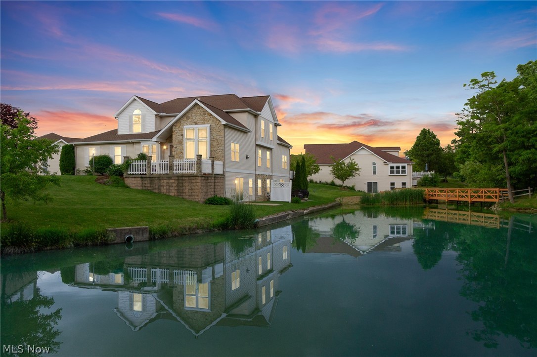 So much to offer! This stunning cluster home offers a fabulous view of the pond. Quality is everywhere you look in this open floor plan home, from the cherry cabinets with Corian countertops, to the cathedral ceilings in the dining and living rooms, to the wide woodwork and the rounded drywall corners. The walkout basement offers a large finish flex space could be for entertaining or separate living with a half bath and large storage space. You need to experience all the natural light in this home for yourself. Call your realtor today for a private showing!