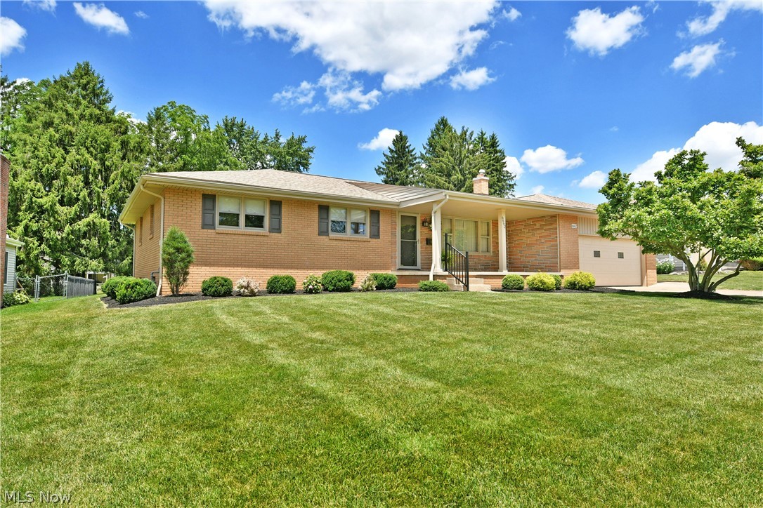 Give yourself an extra reason to celebrate this 4th of July, because you’ve just found the one! Checking all the right boxes and then some, this fantastic Boardman home won’t be around for long, so hurry in now before it’s too late. Offering its high demand, all brick construction and a desirable, three-bedroom layout, this stunner isn’t one to sleep on. Take advantage of the great location, putting you just seconds away from the area’s top shopping and restaurant districts, all while in close proximity to highway and turnpike access for those who commute. Manicured landscaping accents the warm brickwork as the recessed front porch provides instant summertime relaxation. A second, covered rear patio allows you to enjoy the scenic privacy of the lush backyard. Inside, a spacious living room is awash in natural light while hardwood style flooring runs underfoot, continuing into the nearby combined kitchen and eat-in dining room. Jutting islands add to the serving space with potential bar-top seating, all accompanying a tiled backsplash and custom, wooden cabinets. Hidden pantry space is also a plus. Further back, a wood paneled family room showcases its brick lined fireplace and instant rear patio access. Down the main hall, the trio of gracious bedrooms are joined by a colorfully tiled full bath. The master bedroom suite continues to wow with its own, tastefully updated full private bath. Laundry service, a third full bath and available crawlspace storage join the substantial basement below.