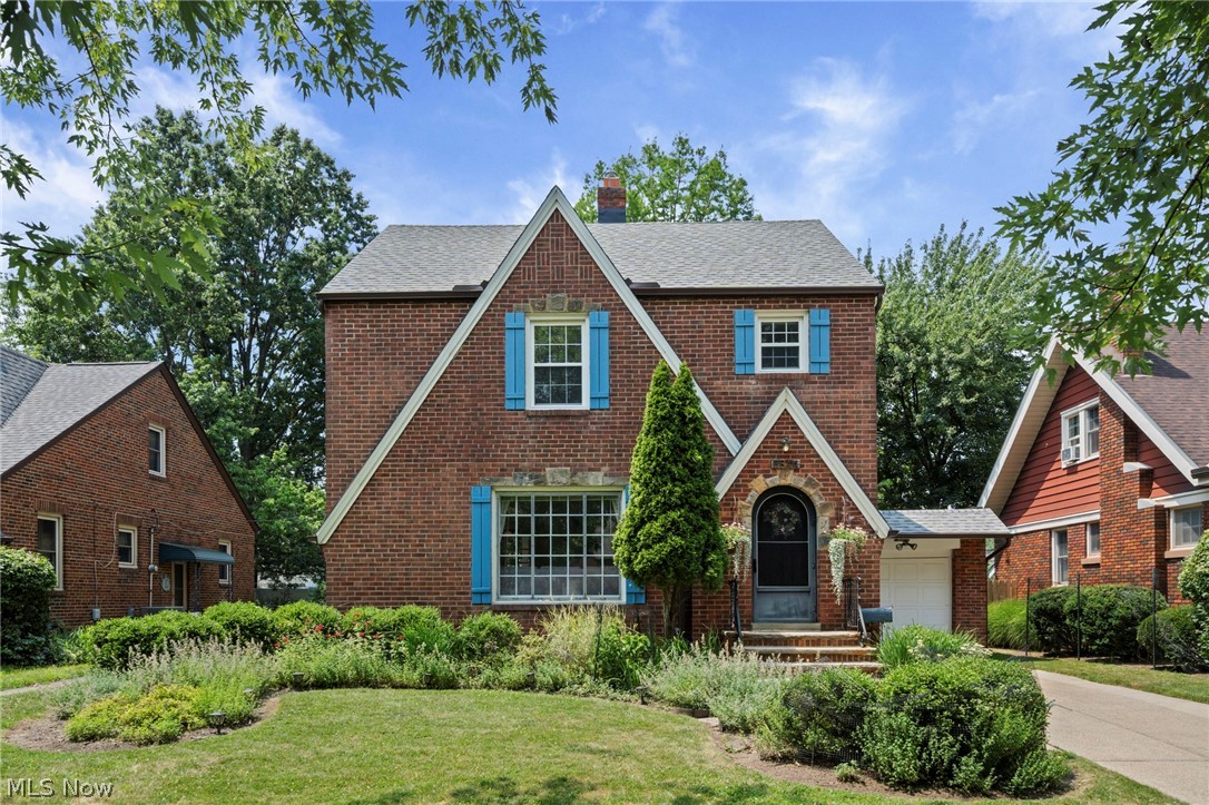 Step into the timeless elegance of this beautifully maintained brick Tudor colonial, where classic craftsmanship meets thoughtful modern updates. From its professionally landscaped grounds and exceptional curb appeal to its inviting interior, this home is filled with warmth and character. Rich hardwood floors, decorative fireplaces, custom built-ins, and distinctive architectural details create an atmosphere that's both elegant and welcoming. The updated kitchen features stainless steel appliances and blends seamlessly with the home's historic charm. Upstairs, the primary bedroom offers a private wood deck overlooking the beautifully landscaped backyard, an ideal spot to sip your morning coffee or enjoy an evening sunset! Below, a covered porch and stone patio, conveniently accessed from the formal dining room, provide wonderful spaces for outdoor entertaining. The partially finished basement expands your living space with a recreation room featuring durable Nature Stone flooring, a second full bath, laundry area, and mechanicals. Outdoor features include an attached one-car garage, storage shed, professional landscaping & herb garden!  This quiet neighborhood has easy access to Big Creek Reservation, shopping, airport & highways. Roof, gutters & downspouts were new in 2024 & the seller is including a one year home warranty! This exceptional Tudor offers the perfect blend of character, comfort, and modern convenience.