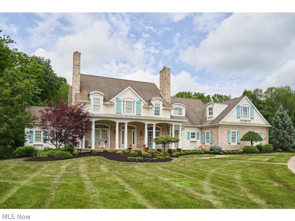 Custom built 5 bedroom, 6.5 bath Cottage style home on private 1.2 acre lot within the swim and tennis community of desirable Firestone Trace in Bath Twp. ALL NEW INTERIOR PAINT, CARPET THROUGHOUT, BRAND NEW LIGHT FIXTURES, & NEW KITCHEN BACKSPLASH!  LOOKS & FEELS LIKE A NEW HOUSE! This home is light, bright, open and cheerful. Chef's kitchen features white cabinetry, high end appliances, walk-in pantry, large island and breakfast bar and is open to hearth room with FP. 1st floor owner's suite with 2 walk-in closets and spacious bath. Mud room with cubbies, large laundry room and half bath complete the 1st floor. Entire 1st floor features hardwood floors. 2nd floor features 3 en-suite bedrooms, and an additional living suite, complete with its own kitchenette and laundry room. Front and back staircases. Finished, walkout lower level features Media room with stadium seating, Rec room with bar (including Kegerator), Exercise room and full bath. Enjoy miles of walking trails within the ne