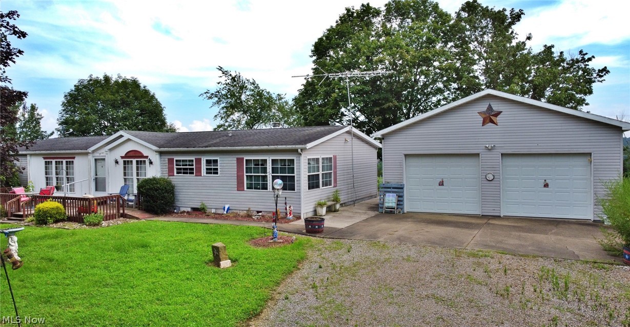 ***Enjoy a full mineral rights transfer for 22.961 acres, including an active producing lease***. This charming 1994 double-wide home, nestled on approximately 23 acres of mostly wooded land, offers privacy and potential. The home features a spacious den with an electric fireplace, perfect for cozy evenings, and a Culligan water treatment system with county water supply. The property includes essential appliances such as a stove, refrigerator, dishwasher, washer/dryer, freezer (in basement), and microwave. The main bedroom boasts two closets and an attached bath with a garden tub. A propane furnace provides efficient heating, and the full, unfinished basement offers additional storage space or expansion potential. The home is complemented by two sizable garages/barns: a 30x40 barn (1992) and a 28x28 garage (1994). The Garage/barn across the drive has water and even bathroom plumbed. The garage next to home has 220V plug and electric panel for your generator as well. Don’t miss this rare opportunity!