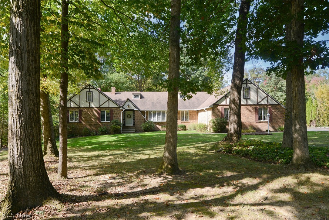 Wow! Looking for an awesome home with plenty of space? One that has a lot of special features you may really fall in love with? Nestled on Whispering Pines, This home boasts a serene location with woodsy backyard setting, easy maintenance landscaping, an attached three car garage and plenty of driveway space with additional parking available. Spacious foyer entry leads to sunken carpeted living room, oversized dining room and spacious kitchen with dinette area, appliances to stay, great counter space for meal prepping and plenty of cabinets with loads of storage! Huge first floor family room with beamed vaulted ceiling, a wet bar, built in shelving, gorgeous brick fireplace and slider doors leading to an enclosed three season room to enjoy those gorgeous wooded views and the wildlife that comes from this setting!  First floor master suite with private full bath and walk in closet! Second bedroom and another full bath on this floor as well. Half bath with previous business as a small sa