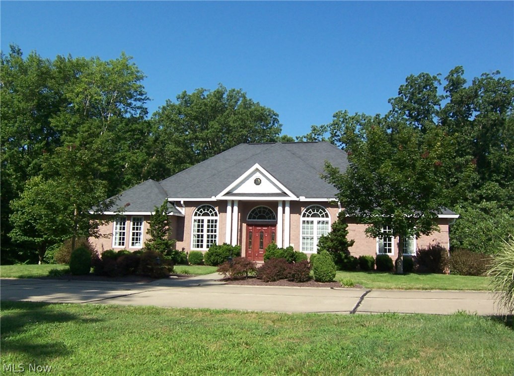 Custom built one owner home designed with elegance & comfort throughout. Large open floor plan with columned entry foyer, hardwood floors, tray ceilings and wide crown molding.  Home features beautiful Cherry kitchen with an abundance of cabinetry and counter space. Sunlit breakfast area off kitchen, cozy den with marble flooring, inviting year round sun room with lots of windows overlooking beautifully landscaped backyard. Second floor media/family room for entertaining. Home is completely hard-wired with surround sound. Central vac on all levels including garage. Enjoy entertaining on this beautiful 28x12 covered back deck with outdoor ceiling fans, overlooking wooded backyard. Last but not least, unique custom showroom garage with ceramic tiled floors and abundance of lighting plus full bath and extra storage area. MUST SEE TO APPRECIATE!!