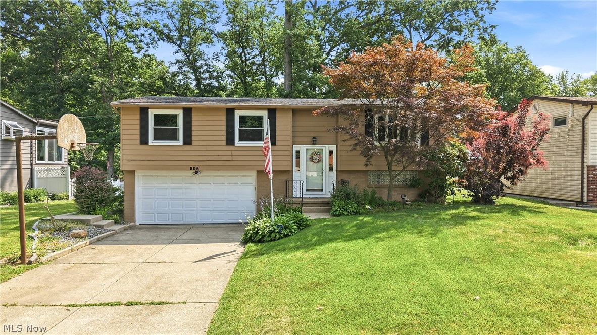 Welcome home to 805 Trumbull Dr., Niles, OH! This well-maintained bi-level home offers 3 bedrooms, 1.5 baths, and an attached 2-car garage, all located in the desirable Howland Local School District. The main level features a bright and inviting living room with brand-new carpet, along with an eat-in kitchen offering warm wood cabinetry, laminate countertops, a pantry, and durable laminate flooring. Just off the kitchen, step onto the covered back deck—an ideal spot to relax or entertain while overlooking the spacious backyard. All three bedrooms are conveniently located on the main level and feature brand-new carpeting, solid wood doors, and generous closet space. The full bathroom includes a tub with surround, a vanity, and tile flooring. The lower level provides additional living space with a comfortable family room, ample storage, and a utility/laundry room complete with a half bath, laundry area, forced-air furnace, central air conditioning, and glass block windows with vents for added efficiency and peace of mind. Outside, you'll find two storage sheds and a large backyard that backs up to Mosquito Creek, offering a scenic setting with added privacy. This home combines comfort, functionality, and a great location, making it a wonderful opportunity for its next owner.