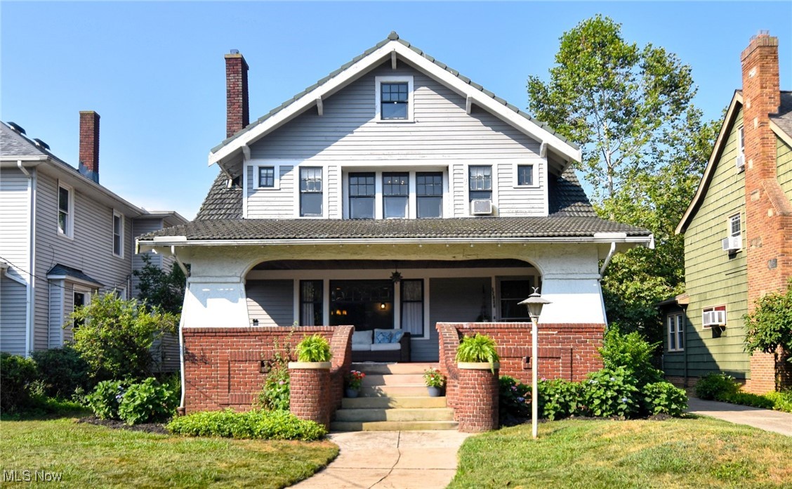 Extraordinary four-bedroom Craftsmen on a quiet Lake Erie street in Cleveland's vibrant North Collinwood community. Exceptional workmanship throughout, with original hardwood floors, artful leaded windows, gorgeous built-ins, period fixtures and hardware. Tall ceilings and abundant natural light. The first floor features and oversized living room with a focal point fireplace opening up to a large, elegant formal dining room perfect for hosting large gatherings. French doors open to an intimate sitting room or den - the perfect spot to enjoy a good book. The classic, bright and open kitchen provides for more functional movement than you typically find in a home of this era, with a charming breakfast nook, plenty of workspace and storage, and a pantry area leading out to the back door. A conveniently located half bath with its beautiful original tiled floor is found between the kitchen and living room. A wide staircase leads you up to the second floor, where you'll find a primary bedroom with deep walk-in closets on each side of the room. Down the hall and you'll find three more amply sized bedrooms, all with adequate storage. The back bedroom features a private covered outdoor balcony overlooking the backyard. You'll also find the archetypal 1920's full bathroom, replete with subway tile and a substantial pedestal sink. The finished basement area boasts a second fireplace, hardwood floors, built-in shelving, and a small kitchenette area.  The mechanical area features laundry, an oversized utility sink, and another full bath. Finished attic for extra storage or play space. Private, shaded, and fenced backyard. Steps down the street you'll find a peaceful lakefront park with seating, pavilion, and playground. Easy access to Lake Erie, parks, shopping and entertainment, hospitals, and the highway. New boiler 2022. New hot water tank 2021.