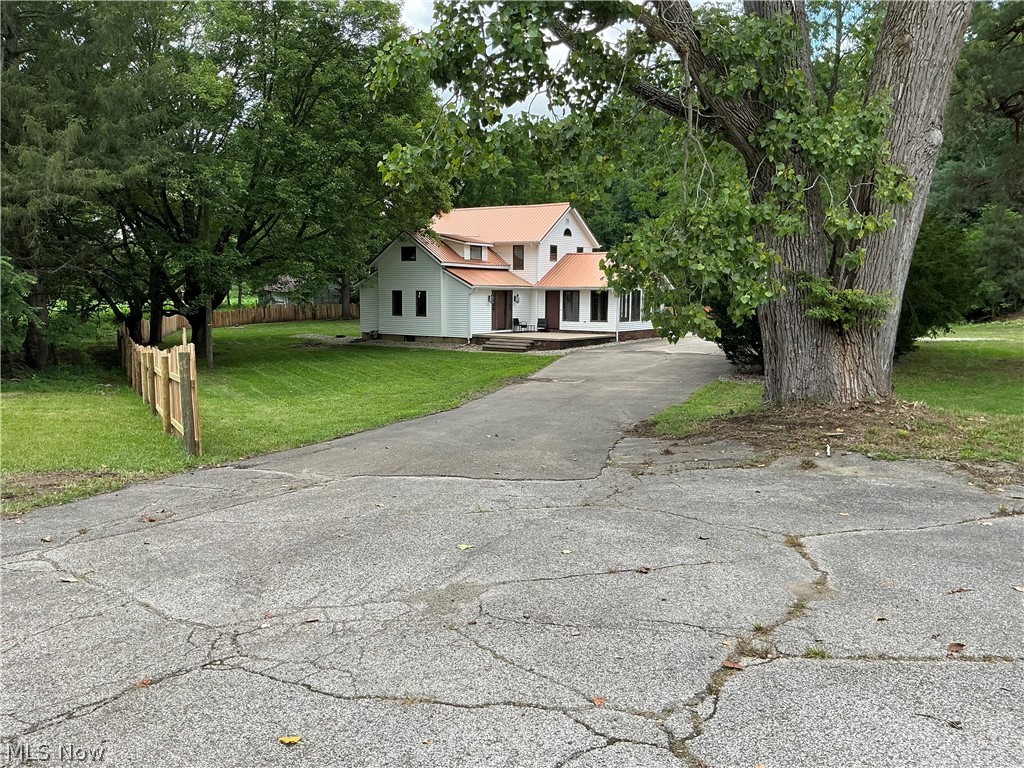 Great country location just outside of Wooster on East Lincoln Way! This 4 Bedroom, 1 1/2 Bath home has been freshly remodeled with almost all new flooring, paint, new cabinets, sink, all new appliances, new septic system, new entrance porch, and a privacy fence around the property line. Here's your chance to buy a nice, move-in ready home and since it sits on 1.218 acres with plenty of elbow room and a nice big backyard it'll be perfect for that growing family! The main floor has the eat-in kitchen with all new cabinets, appliances and flooring, a very nice sunroom with beautiful swirled epoxy flooring and cathedral beamed ceiling, a cozy living room with a new electric fireplace and new carpeting, a large bedroom, full bathroom and laundry with a half bath and a brand new combo washer & dryer as well as an office area with built in desks. There are plenty of closets for storage with the front entrance sporting two and the side entrance has one as well. On the second floor you'll find an additional three bedrooms all with brand new carpet and paint and nice sized closets. The full basement houses the utilities. Outside the metal roof and vinyl siding look almost new and should be worry free for years. There's a large cement patio area perfect for entertaining or just a slow unwind at the end of the day, plenty of parking spaces with the 2 car garage and the paved turn around area. Make arrangements to come see this one today before it's gone!
