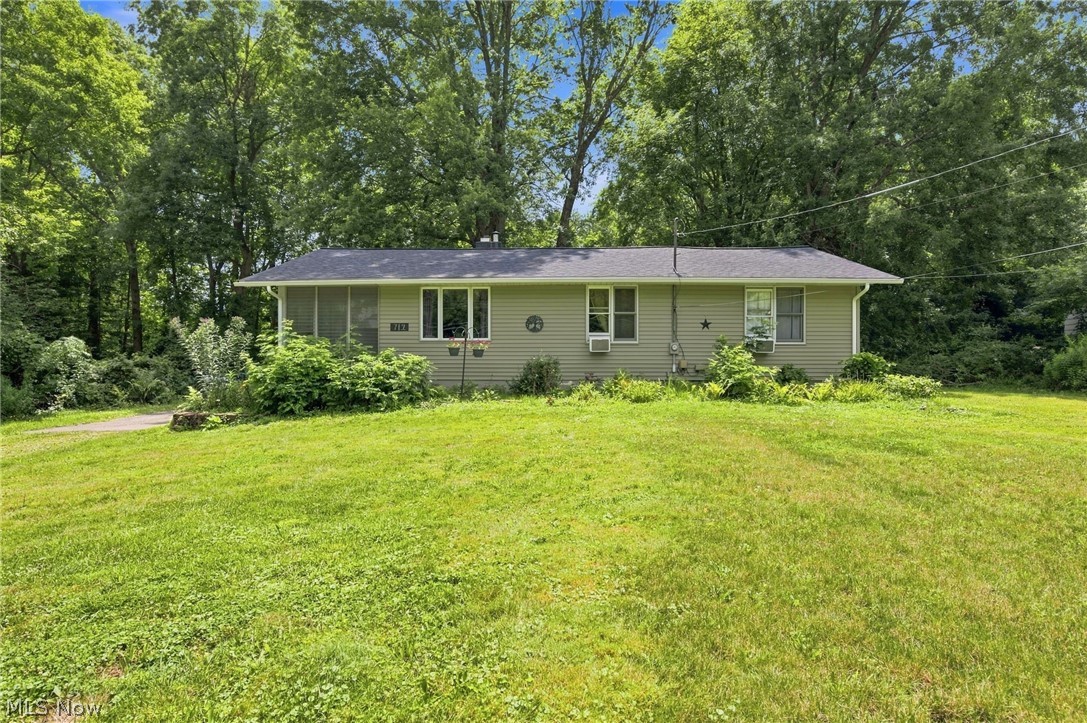 Welcome home to 712 Renninger Rd., a sensibly updated 3-bedroom, 2-bathroom Ranch situated on a peaceful and serene 2-acre wooded lot just 0.3 miles from Portage Lakes State Park. This charming home consists of an enclosed front porch, spacious living room with a floor-to-ceiling brick fireplace, and dining room with direct access to the sprawling raised back deck and gorgeous views of the tranquil backyard. The dining room is also open to the kitchen, which offers more views of the serene backyard and an abundance of cabinetry and countertop space. In addition to the three bedrooms, two of which are quite generous, and two full bathrooms, the home also has a spacious laundry room on the main floor. Outside, there is a one-car attached garage and an unfinished basement, both of which are perfect for additional storage, and a section of the backyard is also fenced in. This home is perfect for those who love nature, privacy, and being exceptionally close to hiking trails, food, water, and all of the amenities that
Portage Lakes State Park has to offer. Updates include but are not limited to: roof, siding, gutters, septic, well pump motor, HWT, basement waterproofing and sump pump, flooring (except in bathrooms), paint, several plumbing components, dishwasher, and washer. Schedule your tour today!