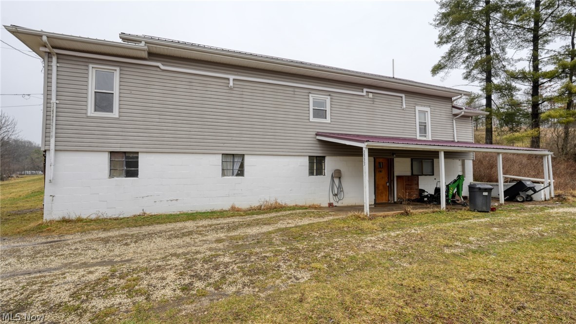 Opportunity awaits with this unique raised ranch home situated on 4.19 acres between Cambridge and New Concord. The layout offers excellent potential for a duplex conversion or multi-generational living, featuring living spaces on both levels with kitchens, bedrooms, and bathrooms on each floor. The upper level includes a comfortable living area, kitchen with breakfast bar and laminate counters, bedroom, and full bath with washer hook-up. The lower level provides additional living space with a second kitchen, bedroom and laundry area—making it ideal for an investment opportunity, rental potential, or separate guest quarters. Outside, enjoy the privacy and versatility of over 4 acres with a mix of open and wooded land, along with a pole barn for additional storage, workshop space, or hobby use. The lower level does need some TLC, giving buyers the chance to update and customize the space to their needs. The heating/air are TopLine Split Systems. Property is being sold AS IS, making it a great opportunity for investors, renovators, or buyers looking to build equity. Whether you're searching for a country home, investment property, or a project with potential, this property offers space, flexibility, and possibilities.