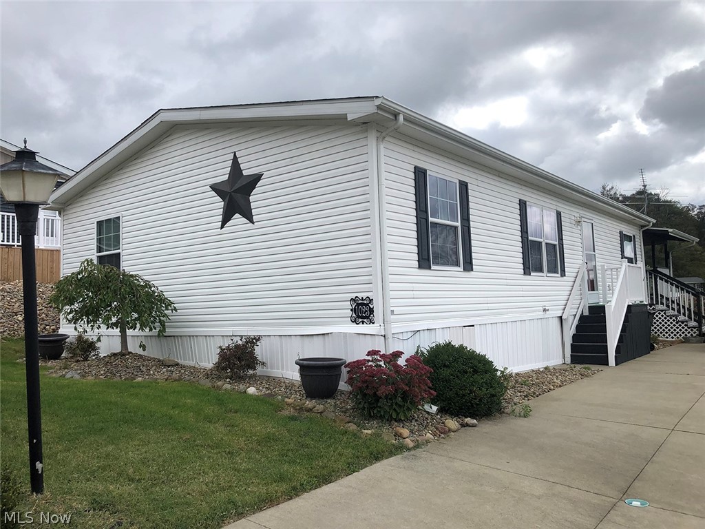Well Maintained Arlington Manufactured Home, built in 2014 w/ 1,248 sqft. The main level features open concept living w/ large fully applianced kitchen including island, dining room, family room & laundry. Master bedroom w/ full bath offers privacy on one end of the home while two additional bedrooms and a full bath are located at the other end of the home. Spacious covered back deck w/ kitchenette is perfect for entertaining. Shed. Public utilities. Parcel #10006680. Quality manufactured home located in Fohl Village w/ great amenities including community pool, clubhouse, basketball courts, and much more!