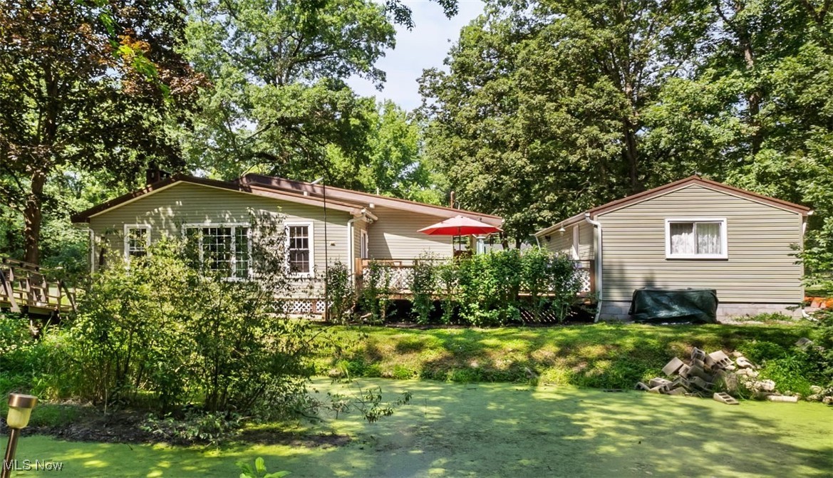 This would make the perfect AirBNB, Summer resort or an all year around residence!  It's beautiful - you will be impressed with it's  unique architect-designed lighted bridge in the backyard nestled on a wooded lot with a creek.  Located in this small community of W. Farmington, this gorgeous home features 3 bedrooms and 1 bath with a high-end walk-in tub, central air, and an open concept kitchen-living room design with vaulted ceiling.  The wood burning fireplace is a showcase that includes a gorgeous insert with blower.  Home has a one of a kind hand-made crafted solid oak cabinet for storage in the master bedroom.  There is a tankless water heater to save energy, money and utility bills.  It has a tucked-away laundry room with plenty of storage, a whole-house water purification system plus Reverse Osmosis water for drinking.  The French doors accent the mudroom which leads to a stylish, deck with plenty of room for outdoor entertaining.  It also includes a single car garage, large pole barn with wood stove and wired electric.   All appliances stay including stand alone 8000 watt generator.  The designated fenced-in area is a safe-haven for children, animals or plant life!  Do not miss this one-of-a-kind property!
