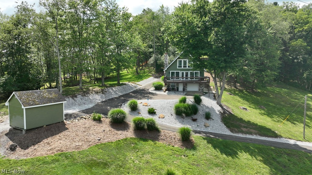Welcome to this beautifully updated home nestled on a double lot in the sought-after gated community of Lake Mohawk!
Perched on top of the hill, this 1.28 acre property offers spectacular lake views and a peaceful setting that invites you to slow down and truly take it all in.  The thoughtfully designed open-concept floor plan offers modern style and functionality with three bedrooms and the potential for a fourth, making it ideal for year-round living or a weekend getaway.  This home features new lighting and beautiful cabinetry throughout, adding both style and warmth to every space.  Imagine cozy evenings around the warm gas fireplace, creating the perfect atmosphere to relax and unwind.  Step outside to the peaceful front deck and take in the sweeping views, or retreat to the private patio out back where you can enjoy the quiet beauty of the wooded lot—perfect for morning coffee, evening conversations, or simply soaking in the serenity.  Extensive improvements include:  metal roof (2022) newer furnace and central air (2022) updated siding, doors, windows, plumbing (2023), including updated tubs and sinks. The interior was extensively renovated in 2023 with updated drywall and cabinetry throughout, creating a fresh, modern feel. Additional improvements include a newer garage door (2026) and newer water heater (2026), along with updated concrete surrounding the home.   
Located in the private Lake Mohawk community, residents enjoy a unique lifestyle featuring a 500-acre spring-fed lake, boating, fishing, swimming beaches, tennis and pickleball courts, a golf course, clubhouse, marina, scenic walking areas, and year-round community events. Whether you’re looking for recreation, relaxation, or a place to call home, Lake Mohawk offers something for everyone.   If you’ve been searching for a move-in-ready home with incredible views, modern updates, and an unbeatable location, this property deserves a spot at the top of your list. Schedule your private showing today!