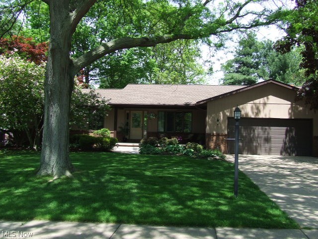 Beautiful 4-bedroom/3-full bath Ranch on rare .6 fenced acre in Tallmadge Highlands. Updated to include removal of two walls to open up floor plan, allowing flow into granite, stainless-steel applianced kitchen w/2 skylights, on into stone/raised hearth fireplaced family room w/sliders to one of the two decks and paver patio.  Kitchen has large granite-topped island with seating area.  Family rm has built-in shelves and granite "buffet/serving" area.  Living rm is currently set up as huge dining rm and dining rm set up as living/sitting rm, openness gives many possibilities.  Sitting rm has sliders to other deck as does master bedrm.  Master bedrm has walk-in closet, "other" area that incl vanity space & master bath.  First floor laundry w/cabinets, counters, utility sink & mud room/side entrance & attached 2-car gar.  Lower level incl 4th bedrm & 3rd full bath along w/large rec rm, plenty of storage area & crawl space for even more storage.  $50,000 worth of updates in last 3 years pl