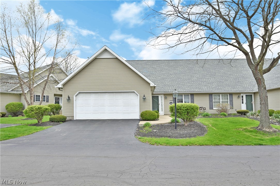 Welcome home!  This beautiful 2 bedroom unit is located in Olde Stone Crossing.  As we drive up you will fall in love the quaintness of the area and as we walk inside you will immediately love the openness of the floor plan.  Let's go to the kitchen where there is tile flooring, granite counter tops and plenty of cabinets.  The kitchen is open to the dining room and great room with vaulted ceilings, brand new vinyl planking flooring and a gorgeous ceiling to floor fireplace.  It feels so open yet very comfortable and homey.  Next you will find the perfect place to have your beverage this time of year.  The 4 season room that sliding doors that overlooks the cement patio.  The yard is beautifully landscaped to give some privacy. The  large master bedroom features a master bath with a tub and shower.  The second bedroom is almost as big as the master! There is also a second full bath and a laundry room.  Every room in the unit has been freshly painted, new flooring in the dining area and