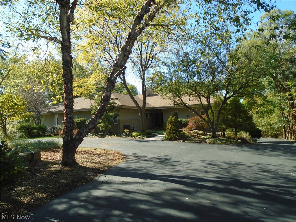 Welcome home to 4100 Kolbe Rd.  Tucked between Fox Creek Golf Club and Lake Erie, this property is one of Lorain counties best kept secret homes!  It is also in the AMHERST school district.  This ranch home logs in over 3800 sq ft of total living area and sits on just over 1.5 acres of wooded property.  The views from the upper wrap around mahogany deck are spectacular and the same can be said for the views from the walk out level deck.  Beautifully maintained and updated by the current owner, (over 60k in updates since 2015) this beauty boasts a custom kitchen with loads of storage, stainless/black appliances and a breakfast nook that has a slider out to a side deck that faces the golf course.  Walking thru to the dining area that walks thru to the great room, both of which have a new wall of windows and 2 doors that lead to the mahogany back deck.  The great room has a series of skylights that allow an abundance of natural light in any season.  Walking thru to the master bedroom and