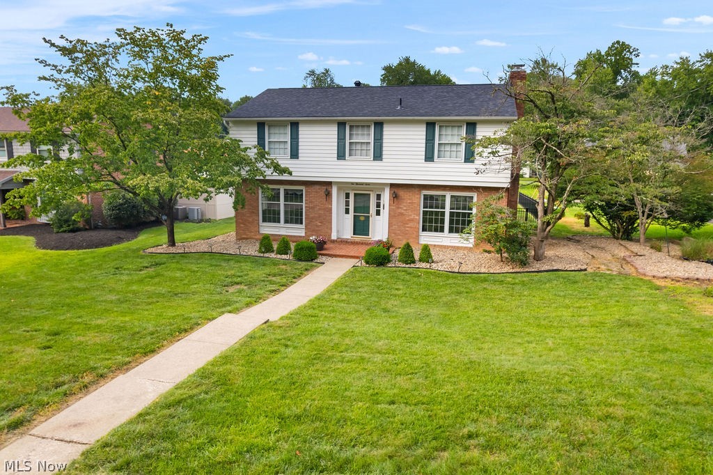 If your looking for a home with location, near amenities, highly sought after schools and a very functional floor plan, look no further.  As you enter the front foyer you have easy access to all the main rooms, and a view of the open foyer area to the 2nd level. There are nice hardwood floors throughout the first and second level living areas. You will enjoy preparing meals in the updated kitchen with room for dining in that space or if not there is a spacious room off the kitchen that can be a multi purpose room plus a updated half bath. Home boasts four nice size bedrooms with a Master ensuite offering an updated private full bath plus the main bath has been updated. Take a break anytime and enjoy the 14x16 screened rear porch that opens onto a large concrete patio area. The lower level offers a large rec room and a 13x24 unfinished storage area with rubber flooring. Home provides paved alley access, partially fenced rear yard, and double attached garage.