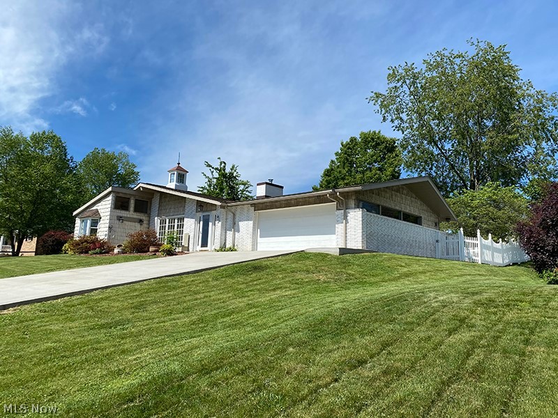This home is a true delight inside and out featuring 2187 square feet of light filled living space and situated on approximately 1/3 acre. The features are many starting with inlaid imported marble floors, stile & rail 6 panel quarter sawn red oak doors, red & white oak wood trim throughout, freshly painted interior, new carpet in Living Room, Master suite, 3rd bedroom and hall. Many large Anderson windows. New Amish installed concrete driveway and roof. Updated kitchen appliances and custom hickory kitchen cabinets. Real stone and marble floors in kitchen, dining, laundry, foyer and mudroom. Extensive interior masonry. The outdoor space includes a completely enclosed back yard with white picket fence, a large custom built storage building with mezzanine on a concrete foundation, and a large back patio area. Public water will be connected prior to closing.