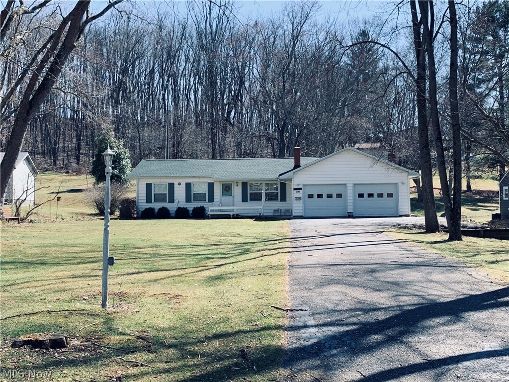 Almost half an acre edge of  town perfection! Original owner of this med-century home. 3 bedrooms, 1 bath, screened-in back patio, eat-in kitchen with beautiful picture window, and family room addition with brick gas fireplace. Extended open kitchen area overflows into the family room-great for large gatherings.  Attached 2 car garage. Full basement with wood burning stove and electric hot water tank. Hardwood floors in bedrooms. Newer front windows, copper plumbing, gutter guards, electrical panel 200 amp, whole house generator, and roof(2016).