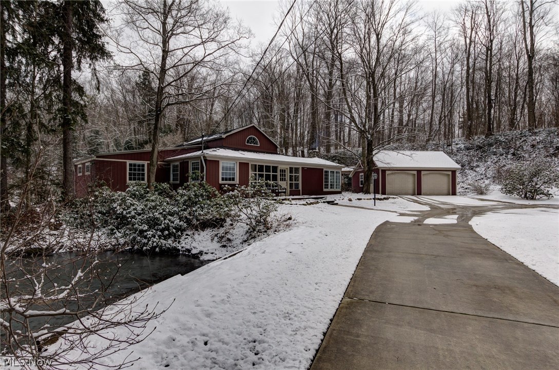 Imagine, Your Home Nestled in 3.5 acres Landscaped by Nature with the Music of the River & Your Very Own Waterfall! Next to a stream fed stocked pond, an enclosed porch leads you inside. Exposed beams & character throughout. A Stone wood burning fireplace enhances a wormy chestnut accented living rm. Thoughtful office/mudroom w/hardwood floor has endless views of rear oasis. Master kitchen features, vaulted ceiling, cork flooring, abundant custom Knotty Pine Cabinetry, Vermont Soap Stone Counters, Stainless Steel Viking Stove/Fridge & wood burning stove.1st Island w/prep sink & breakfast bar & 2nd more cabinetry. Spiral steps to a creative loft space. 1st flr Laundry remodeled ’12. Updated Full bath has soaking tub/shower & hardwood flooring. Skylight in Library w/decorative fireplace, built in wood shelving & hardwood flooring offer that perfect reading place. Master Suite includes beamed ceiling, large windows & door to rear deck/hot tub. Private Master Bath updated w/heated floors &