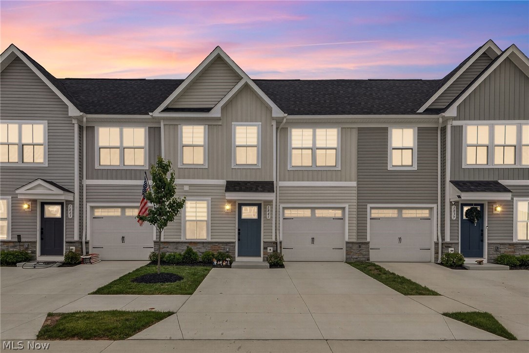 Welcome to 1841 Shank Drive in the desirable Riverwood community. This charming attached single-family townhome boasts a versatile design featuring one-level living, two upstairs bedrooms, and a one-car attached garage. Approximately 14 years remain on the 15-year tax abatement, providing substantial annual savings. The low HOA fee of just $175 per month includes grounds maintenance, snow removal, and access to the community dog park. Situated in beautiful Merriman Valley with convenient access to shopping, restaurants, Cuyahoga Valley National Park, and the Woodridge Local School District, this low-maintenance, sparkling-clean townhome is an absolute find! The bright, open main level features LVP flooring and recessed lighting throughout. A comfortable, spacious living room is perfect for entertaining or relaxing. The large, airy kitchen boasts stainless steel appliances, a custom tile backsplash, quartz countertops, and an oversized 8'+ island with seating for four. The spacious dining area provides access to a cozy covered porch, perfect for morning coffee. The primary bedroom, located at the rear of the home for added privacy, offers peaceful nights and includes an ensuite bath with a double vanity, tile shower with built-in seating, and a generous walk-in closet. A separate laundry room and half bath complete the main level. Upstairs are two nicely sized bedrooms that share a hall bath. A linen closet, semi-finished storage room, and utility room with a high-efficiency Carrier furnace and tankless water heater complete the upper level. Don’t miss this fabulous townhome in a lovely, walkable neighborhood close to everything. You can also experience the home through the immersive 3D virtual tour and detailed 2D and 3D floor plans!