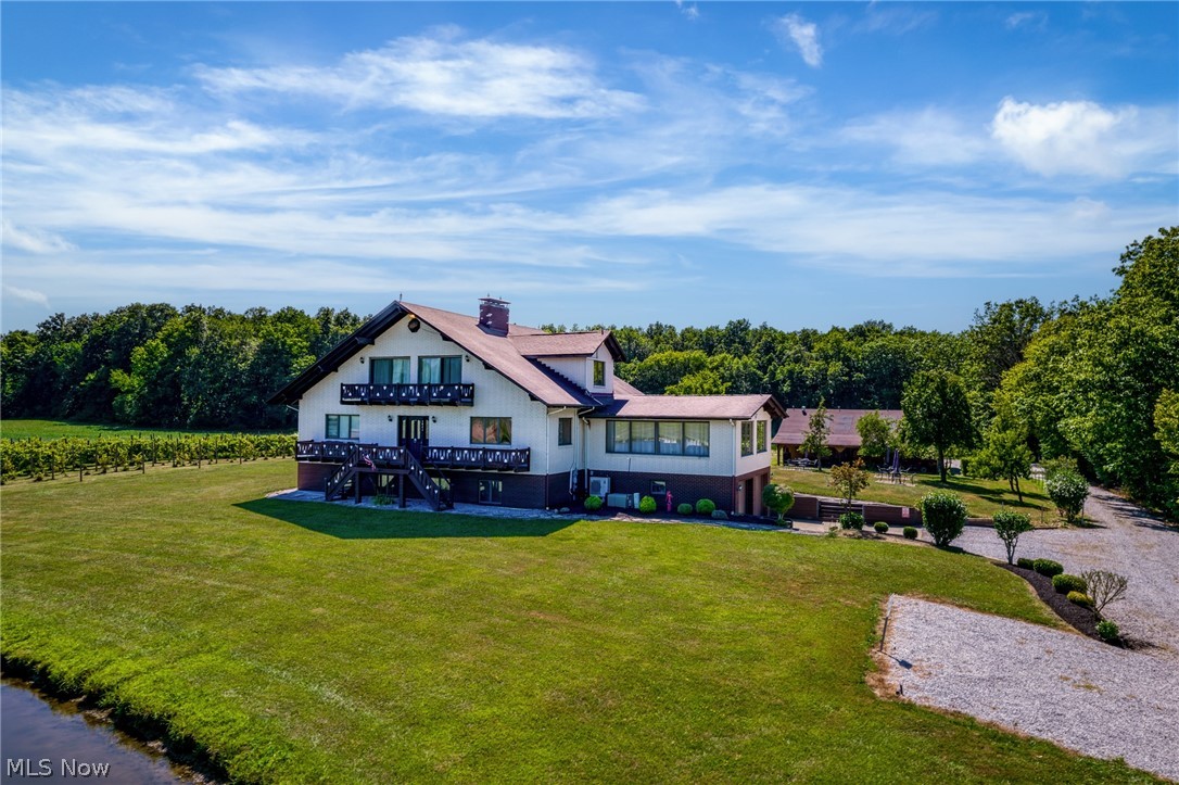 Welcome to your own private retreat in the heart of Ohio wine country! Situated on 5 scenic acres, this unique property offers the perfect blend of rustic charm, peaceful living, and endless opportunity. Whether you’re searching for a full-time residence, weekend getaway, income-producing short-term rental, or future event venue, this property is ready to bring your vision to life. Enjoy serene pond views with a charming gazebo, beautifully landscaped grounds, and picturesque orchard and vineyard views from the rear balcony. The versatile barn with water and electric offers incredible flexibility for hobbies, storage, workshop space, livestock, or entertaining. Inside, the home features a primary suite with a spa-inspired marble bath and jacuzzi tub, a heated sunroom for year-round enjoyment, and an expansive lower level complete with a family room, built-in bar, wine cold storage, laundry area, and multiple bonus rooms perfect for guests, office space, or creative use. Additional highlights include zero-cost natural gas access from an adjacent well for efficient heating and the potential to purchase furnishings, wine-making equipment, and event seating separately. Conveniently located just minutes from Rt. 90, local wineries, SPIRE Institute, Geneva-on-the-Lake, Lake Erie, and the area’s iconic covered bridges, this one-of-a-kind property combines natural beauty with exceptional potential.