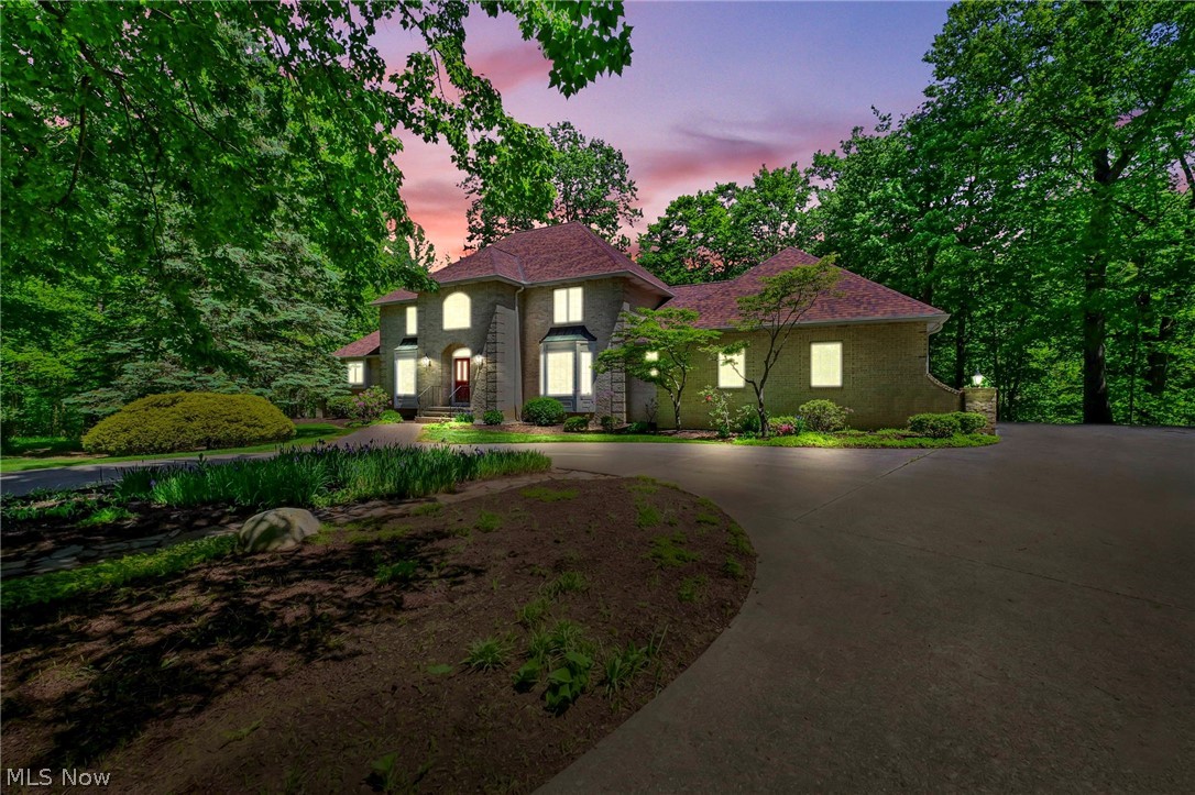 Tucked away on 3.16 private wooded acres in desirable Regency Woods, this custom-built colonial offers an exceptional blend of space, privacy, & timeless design. With 4 bedrooms, 4 full baths, & 2 half baths across more than 4,400 square feet, the home is thoughtfully designed for both everyday living & entertaining. A dramatic two-story foyer creates an impressive welcome, while expansive living spaces throughout the home are filled with natural light & surrounded by peaceful wooded views. The great room features soaring ceilings, hardwood flooring, & a striking floor-to-ceiling stone fireplace, creating a warm yet sophisticated gathering space. A private first-floor office with custom built-ins offers the perfect work-from-home setup. The kitchen is generously sized with abundant cabinetry, center island, & an effortless flow into the main living areas & outdoor deck. The dining room provides an elegant setting for entertaining, while the spacious first-floor primary suite offers comfort, privacy, & a well-appointed ensuite bath. Upstairs, 3 additional bedrooms & multiple full baths provide flexibility for family & guests. The finished, walk out, lower level expands the living space with large recreation areas, built-in shelving, game room, full bath, & private sauna ~ ideal for entertaining or relaxing at home. Fan Favorite ~ 2nd stairway to the garage!  Outdoor living is equally impressive with an expansive deck overlooking the serene backyard. Ideally located near some of Northeast Ohio’s scenic park systems, the home offers convenient access to Penitentiary Glen, Lake Farm Parks, Holden Arboretum, and Chapin Forest. All part of the natural beauty of the region and the lifestyle often associated with Northeast Ohio’s Emerald Necklace. Located within the highly rated Kirtland Local School District, this property offers a rare opportunity to enjoy estate-style living in a peaceful setting while remaining convenient to shopping, dining, & major commuter routes.