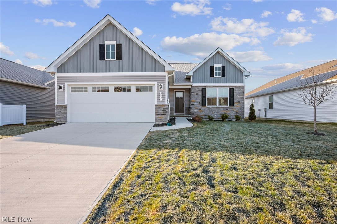 Nearly new 2023-built Craftsman-style ranch in the Hidden Village community, offering a sought-after spacious open floor plan, covered deck with steps leading to the backyard, full basement ready to be finished with egress window, and the convenience of one-floor living in Perry Local School District. This thoughtfully designed and upgraded throughout home features approximately 1,736 square feet, 2 bedrooms, 2 full baths, and a flexible den/flex room that can easily be converted to a 3rd bedroom if needed. This property INCLUDES MANY FEATURES that are not typically included in new construction such as all kitchen appliances, washer, dryer, 2nd fridge in the garage, window treatments, a fireplace, landscaping installed, tv over fireplace  and more. The upgraded eat-in kitchen complete with granite countertops, a large center island with seating, stainless steel appliances, and a dining area with direct access to the covered deck. The private primary suite includes a walk-in closet and an upgraded en-suite bath with a double vanity and Roman walk-in shower with a built-in bench. Additional highlights include a first-floor laundry room with washer and dryer included, an attached 2-car garage, and a full basement featuring an egress window, plumbing for a future full bath, and ample storage providing excellent potential to expand the home's living space. Conveniently located near I-90, Route 2, shopping, dining, and other local amenities.