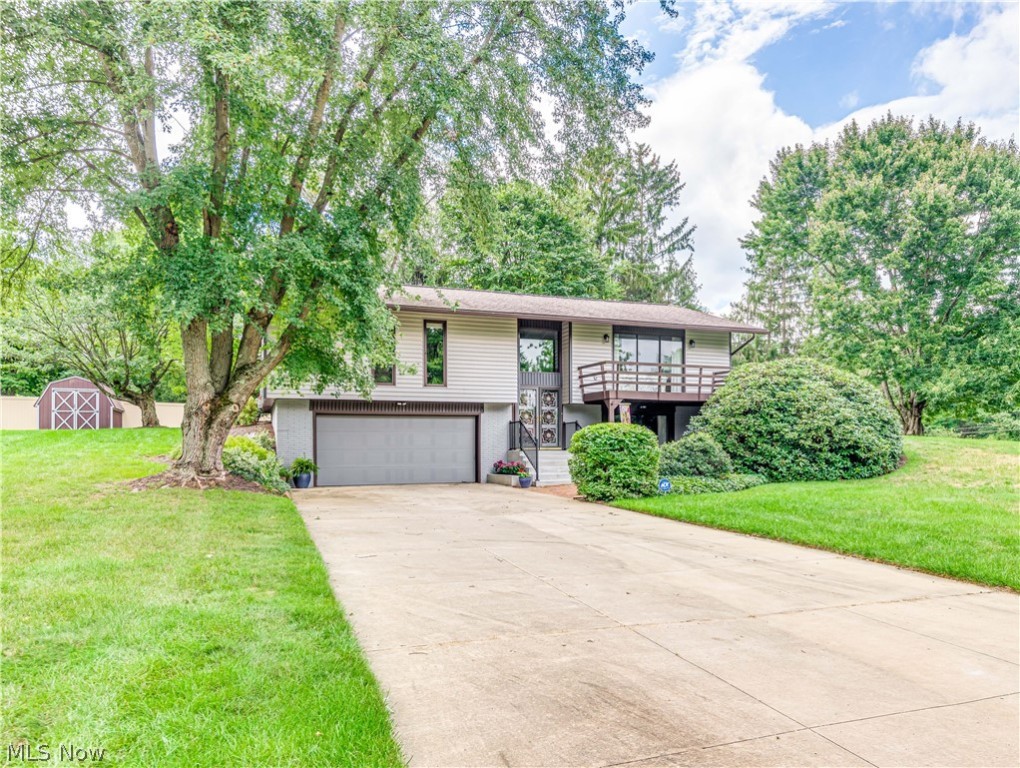 Meticulously kept since 1972, this one owner beauty is situated on a picturesque one-acre treed lot. As soon as you walk in the front door you become aware that the oversized windows and sliding doors allow the entire home to be drenched in natural sunlight.  The sizable formal living room offers sliders to the front deck and the dining room sliders lead to the screened-in back porch.  A spacious eat-in kitchen includes a convenient breakfast bar, all appliances and leads to the back porch. The master bedroom boasts an ensuite bath. Another full bath and two other well sized bedrooms complete the main level.  The lower level boasts a huge family room with a gas fireplace and sliding doors that lead to a brick patio.  A half bath, storage area and laundry room complete the lower level. Entry to the two-car garage is in the lower level. As perfect as the inside is, the exterior has much to offer.  A 28x16 screened in porch comes complete with a hot tub and includes custom blinds. The por